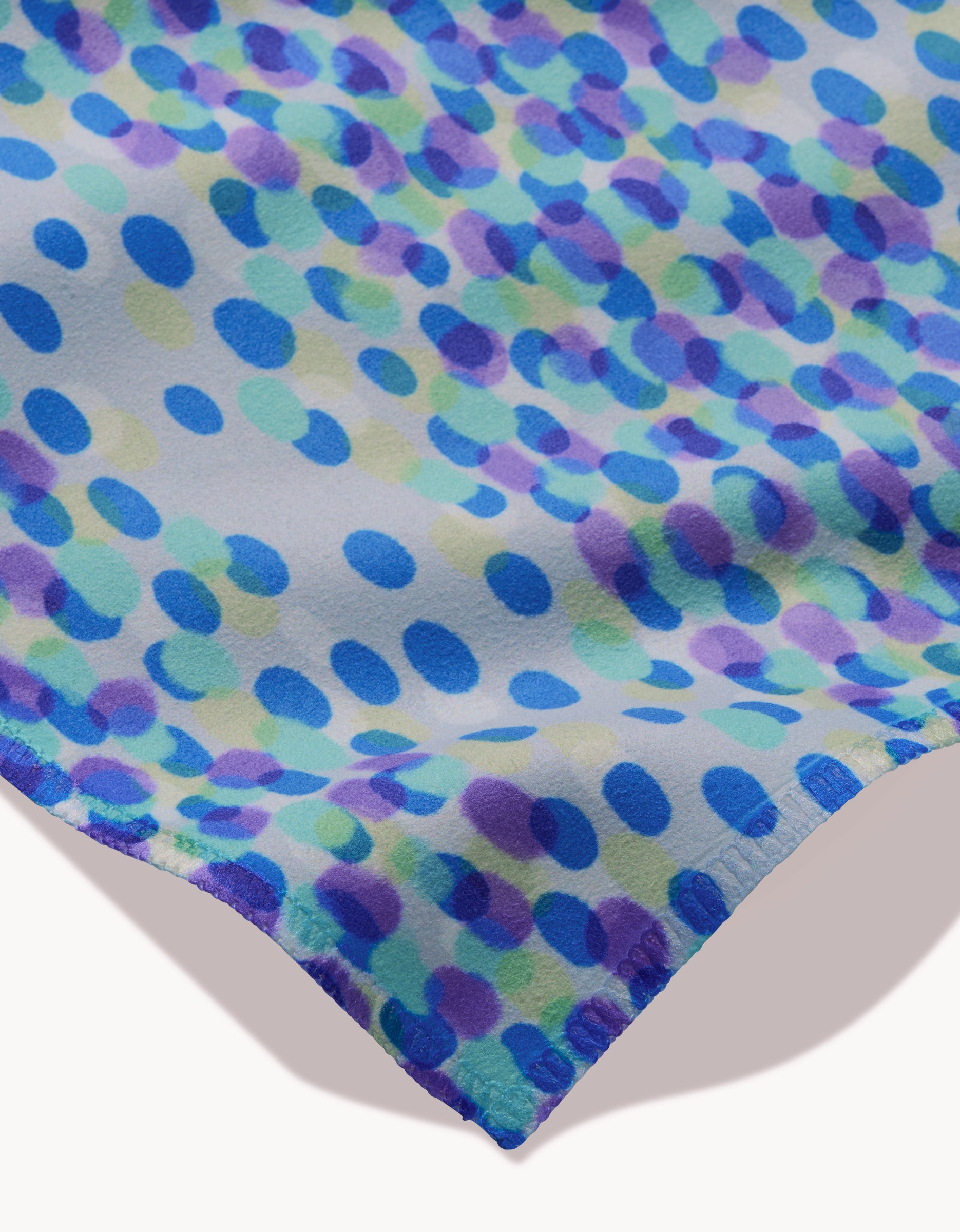 The GEOMETRY Spotty Summer features blue, turquoise, and purple dots on a white background. This soft, lightweight fabric is ideal for a set of absorbent cloth napkins.