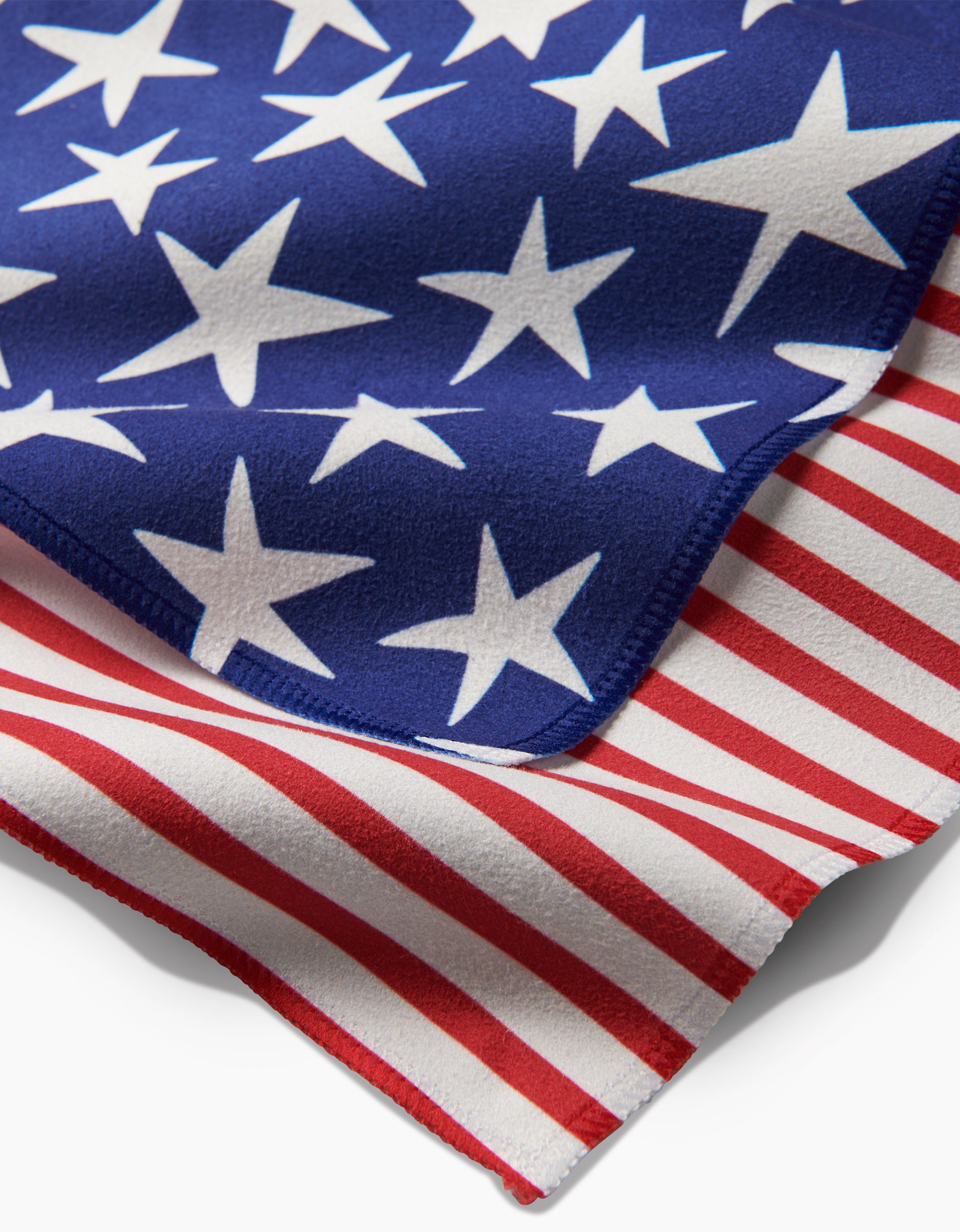 A close-up of Mindfulnices Stars And Stripes fabric shows blue geosuede with white stars layered over red and white stripes, echoing the American flag design.