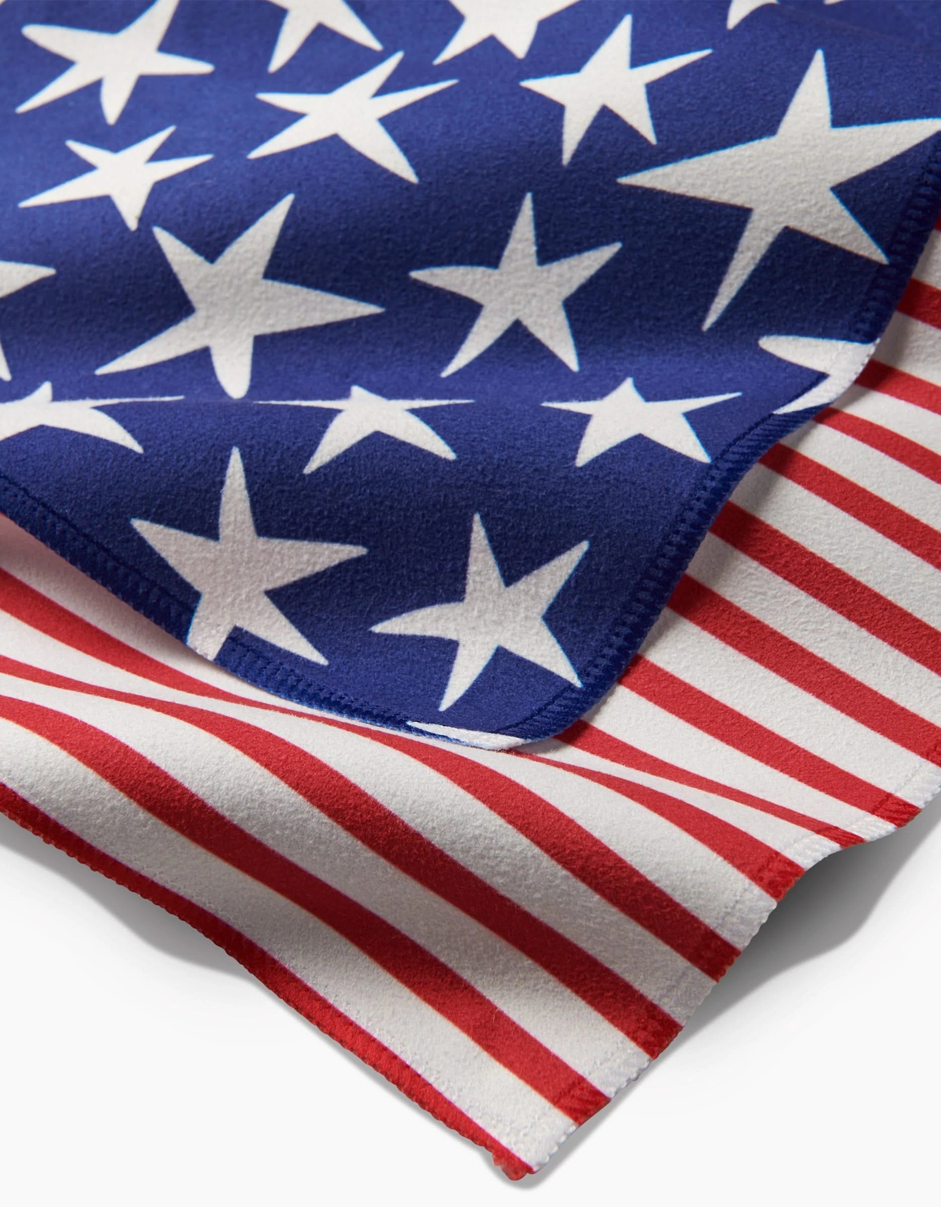 A close-up of Mindfulnices Stars And Stripes fabric shows blue geosuede with white stars layered over red and white stripes, echoing the American flag design.