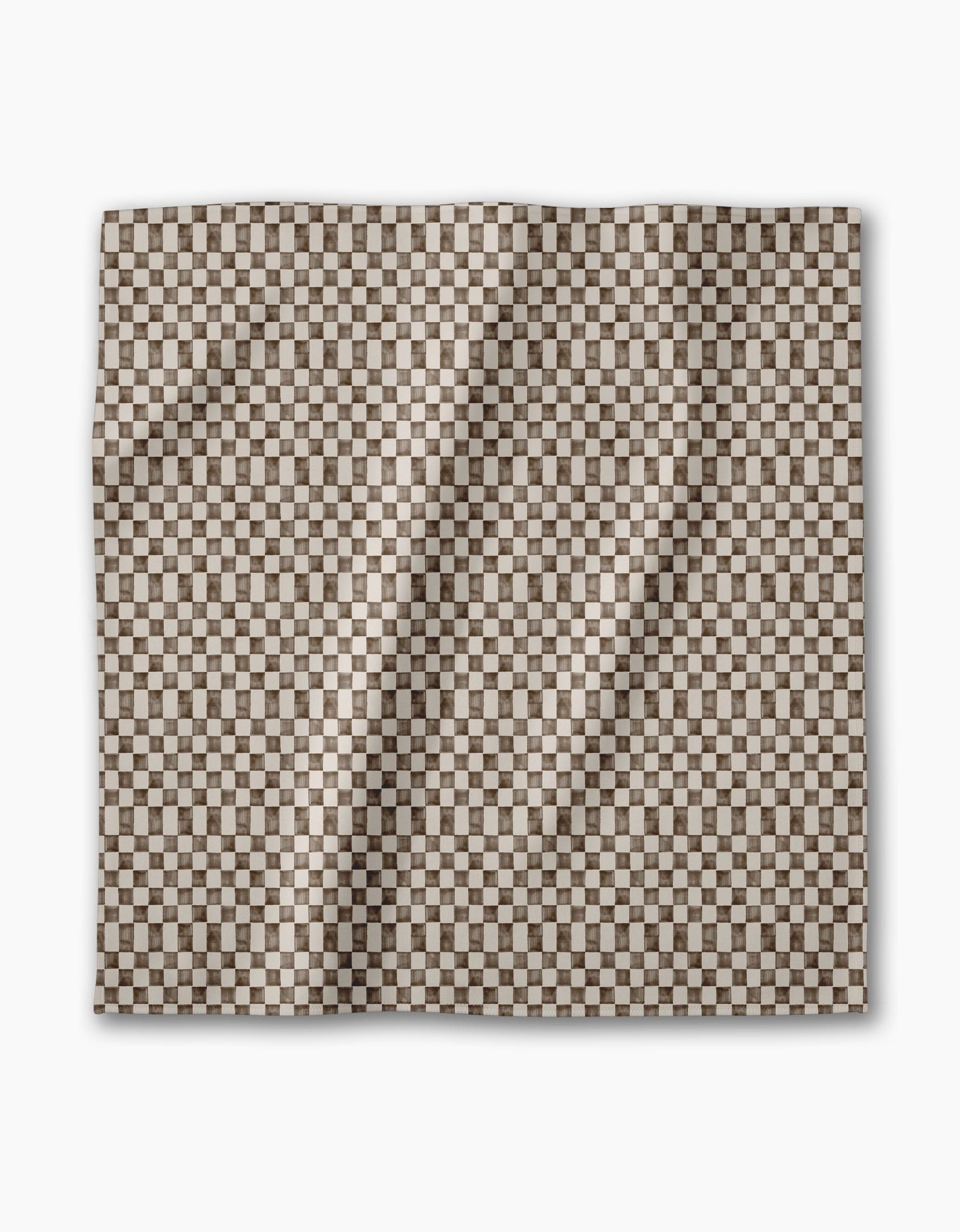 The Geometry Tavern is a square dinner napkin with a small brown and white checkerboard pattern. Eco-friendly and neatly folded, it’s showcased against a plain white background.
