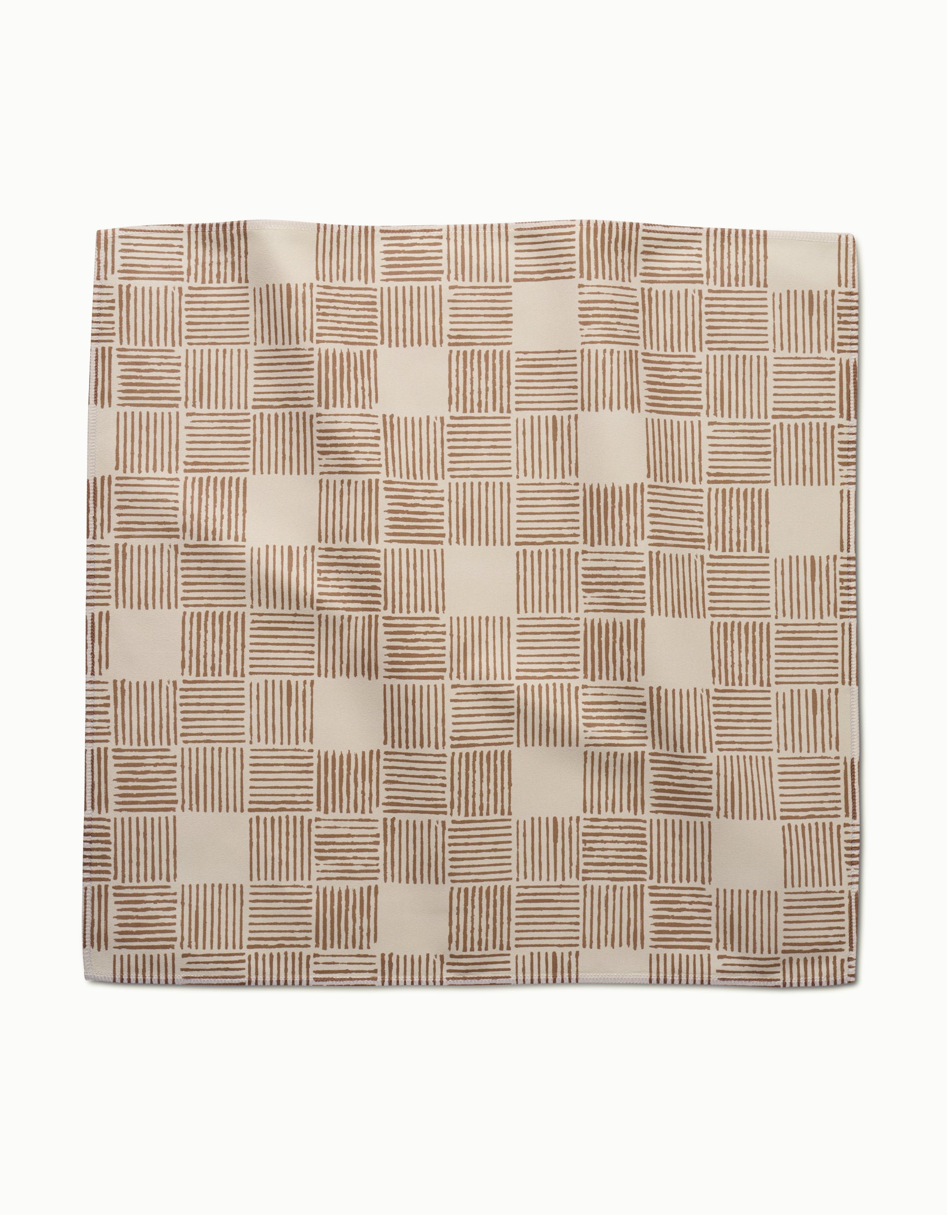 The Thatcher Dinner Napkin Set by Studio Jeannot features eco-friendly Geosuede fabric, showcasing brown hand-drawn grid squares with parallel lines on white for elegant, sustainable dining.
