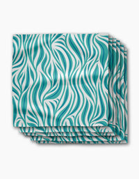Four stacked Willow Wave dinner napkins by Rachel Parker, crafted from recycled Geosuede fabric with a wavy teal and white abstract pattern, set on a plain white background for an eco-friendly touch.