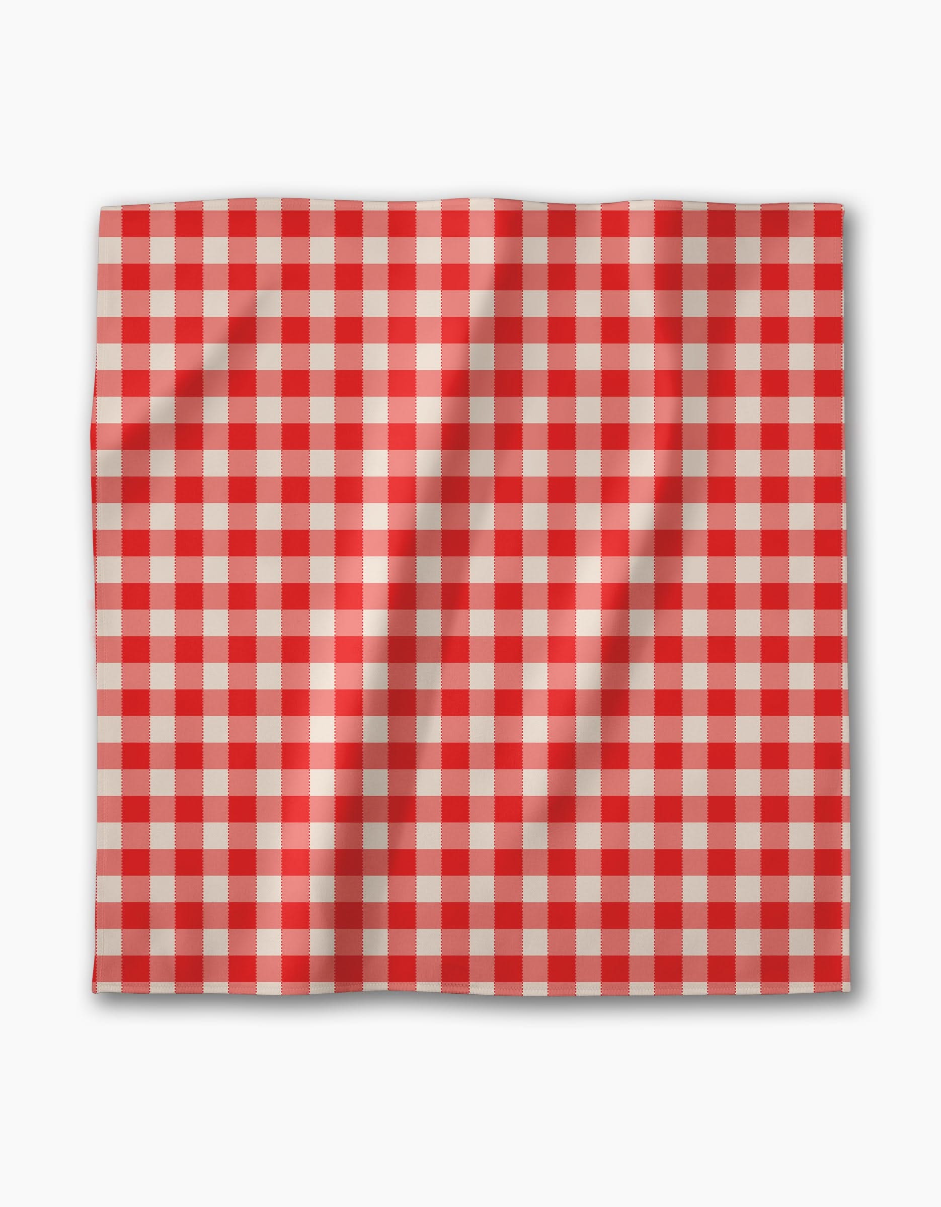 The Geometry Ripe Tomato Gingham dinner napkin set features square Geosuede fabric with a red and white checkered pattern, shown with gentle folds against a white background.