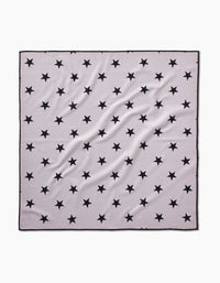 The Bark scarf by Geometry is a square, light gray piece made from recycled materials, featuring a pattern of evenly spaced black stars, a thin black border, and slight fabric wrinkles.