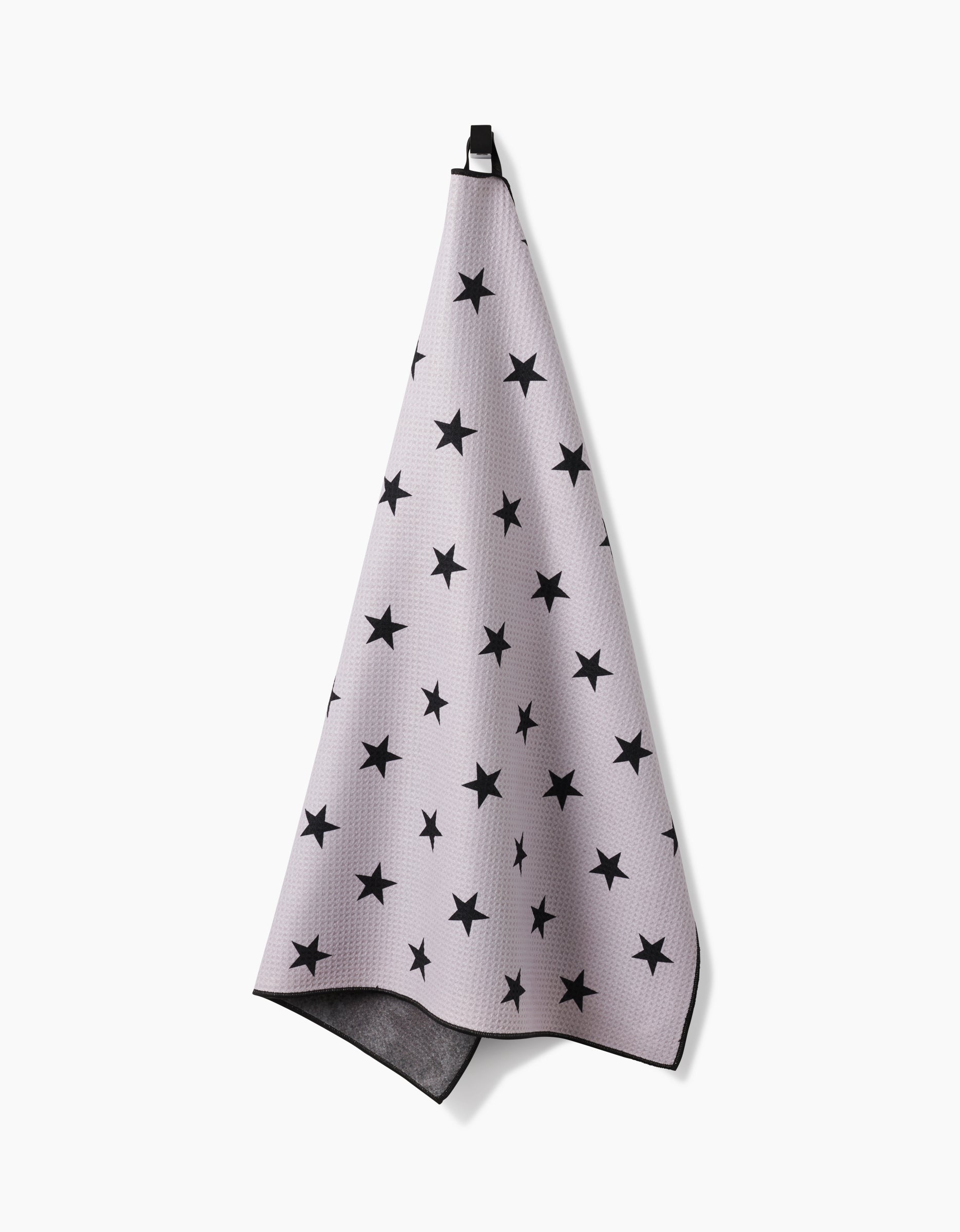 The Geometry Bark towel, in light gray with black stars and a black hanging loop, is highly absorbent and displayed against a white background.