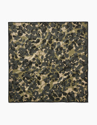 The Geometry Camo pet towel is a square, eco-friendly towel featuring a green, black, and beige camouflage pattern on a white background.