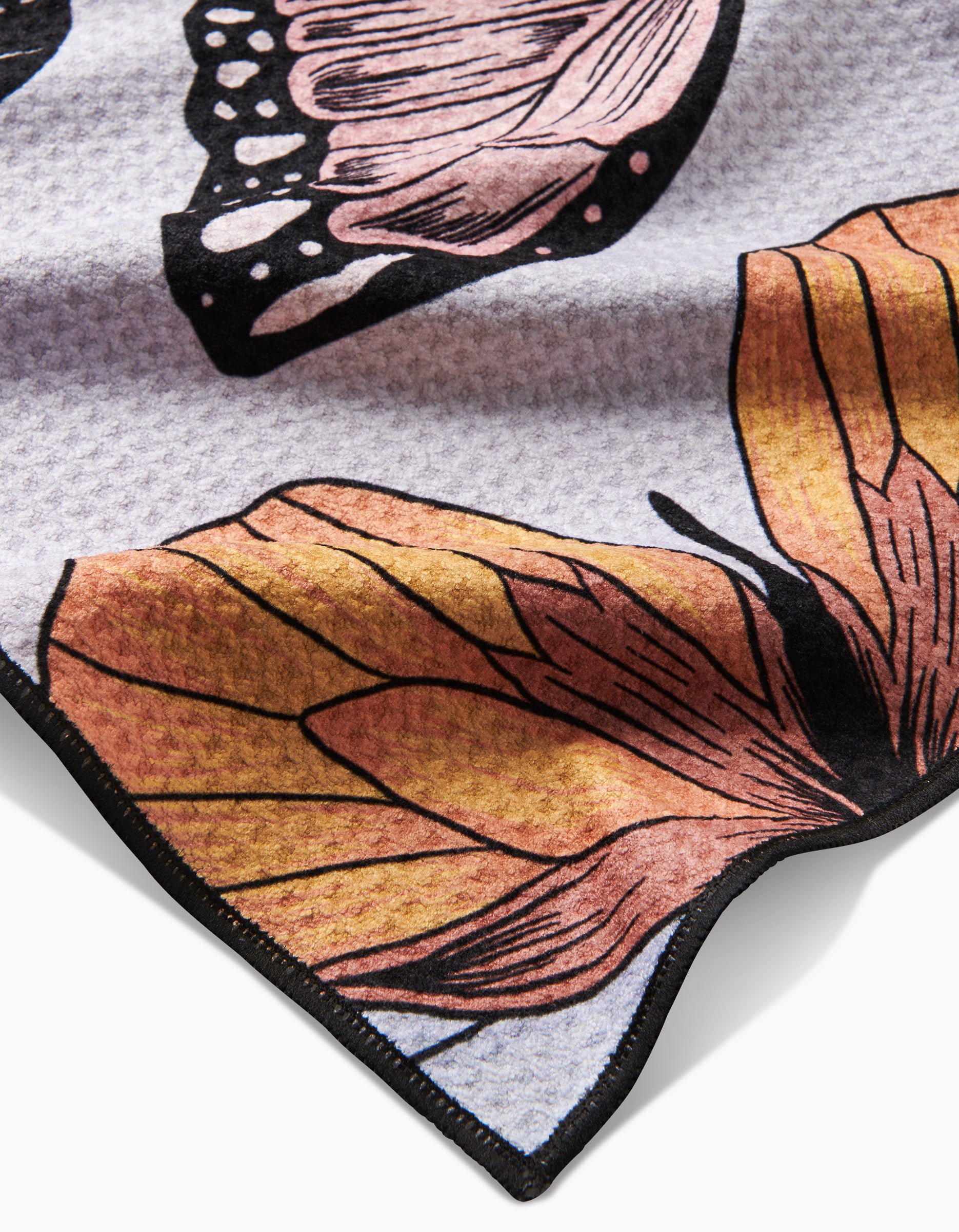 Close-up of Geometrys Cute Butterflies fabric, showcasing a vibrant butterfly wing pattern in orange, pink, and black with a black edge, sustainably crafted from recycled materials.