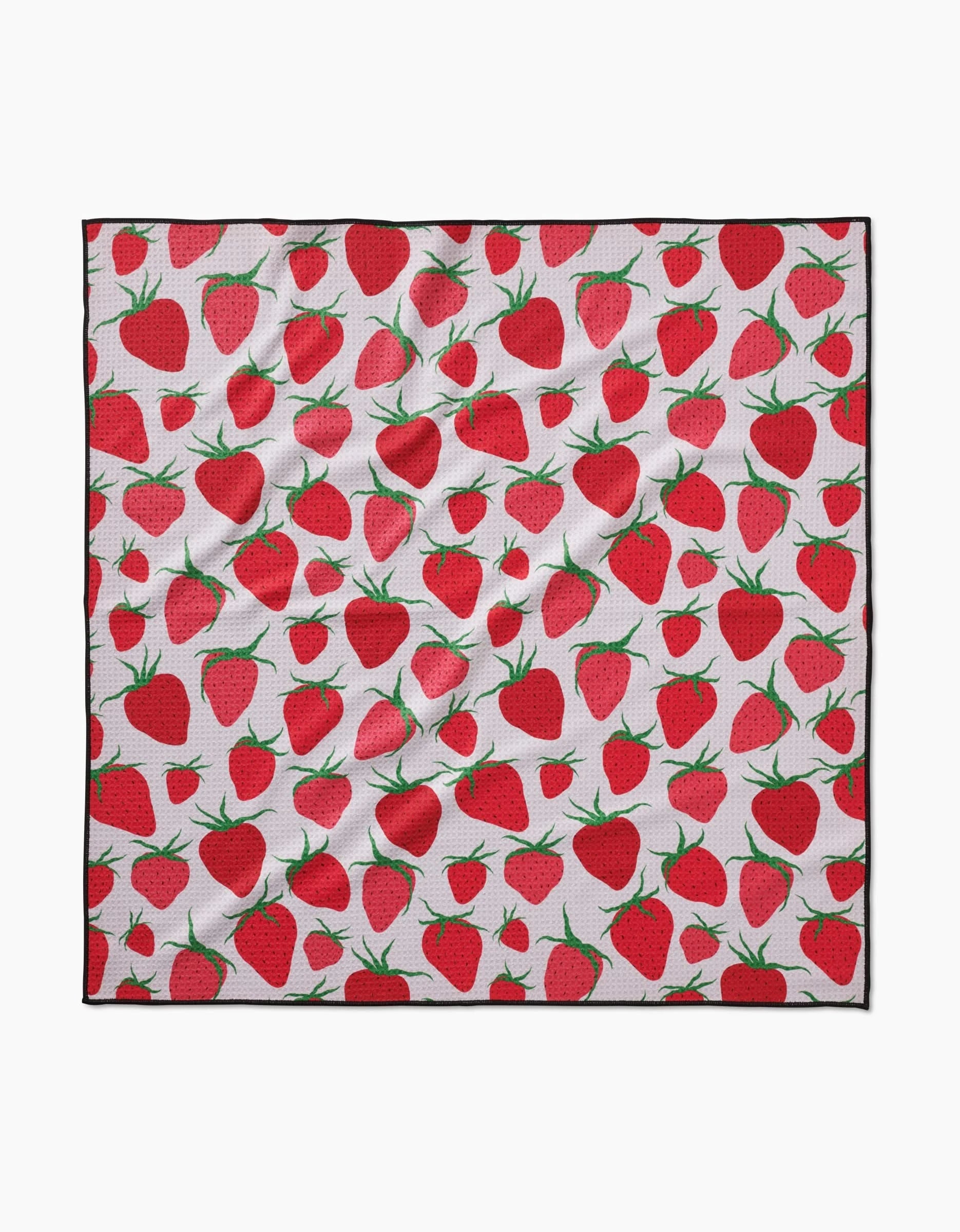 The Geometry Strawberry Sniff is a square white dog towel with a vibrant red strawberry and green leaf pattern, made from absorbent, eco-friendly fabric that appears slightly wrinkled.