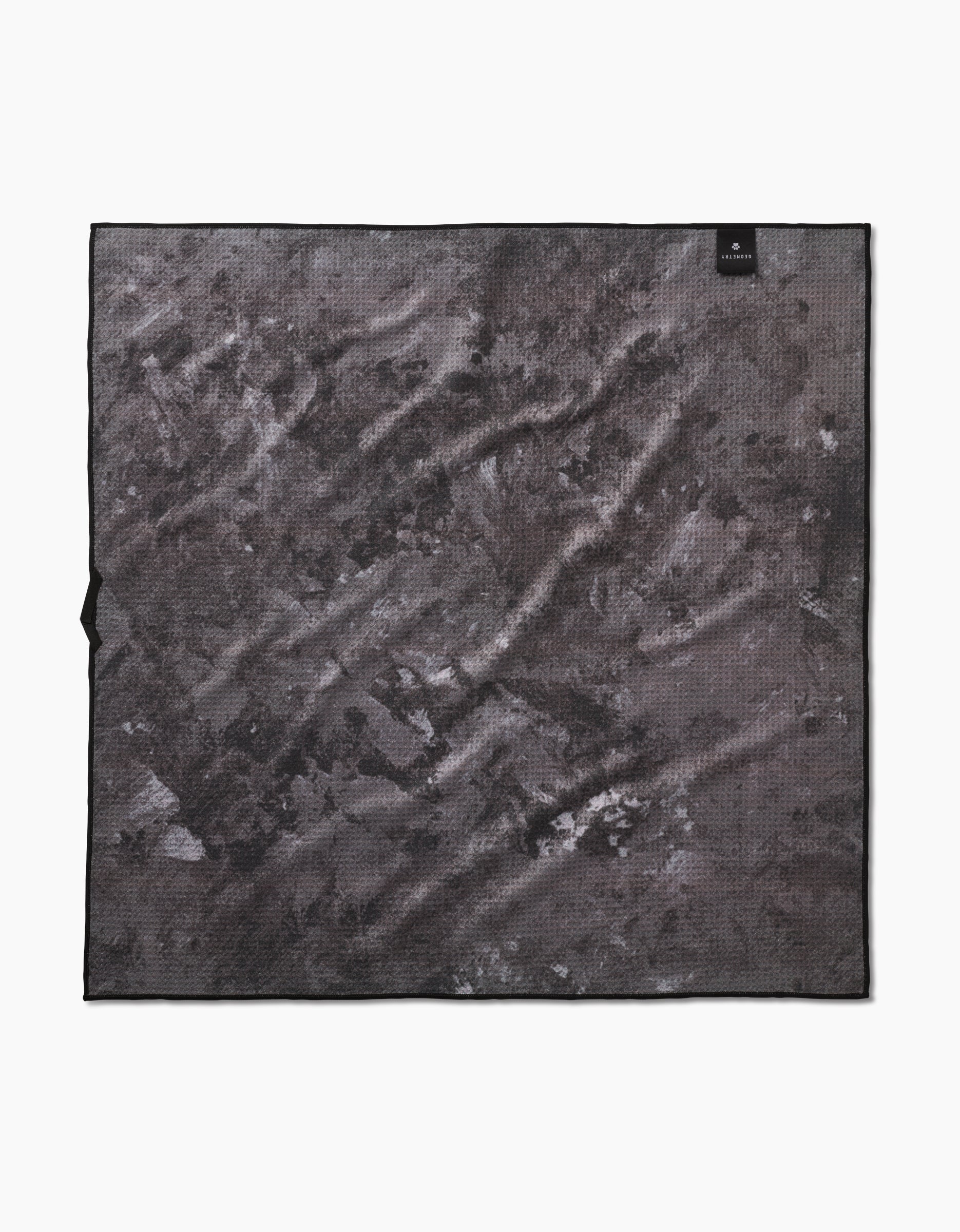 The Geometry Feeling Sunny Dog Towel is large, square, and dark gray with a marbled pattern and a black corner tag. Highly absorbent and quick-drying for mess-free convenience. Displayed flat on a white background.