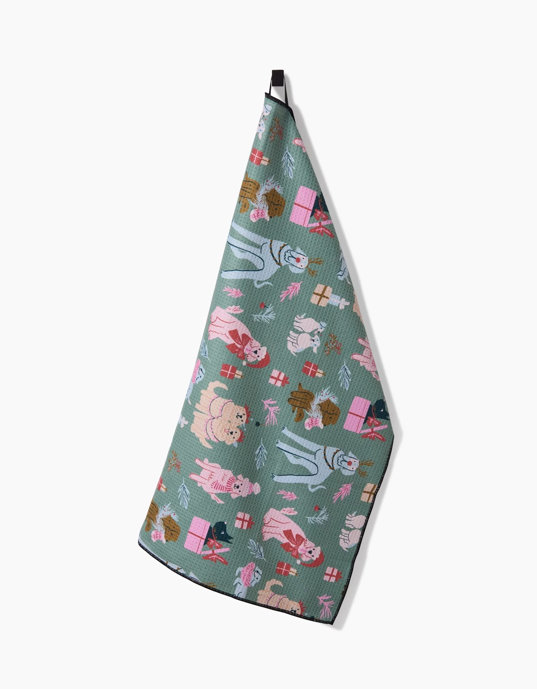 The Christmas Doggos kitchen towel by Janna Sue Design features festive dog illustrations in pink, blue, and brown on recycled green fabric with a black hanging loop, adding holiday cheer to your kitchen.