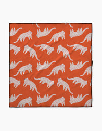 The Cute Cheetah blanket by Jennifer Bouron is lightweight and eco-friendly, featuring a repeating pattern of white cats with pink spots in a walking pose on an orange background.