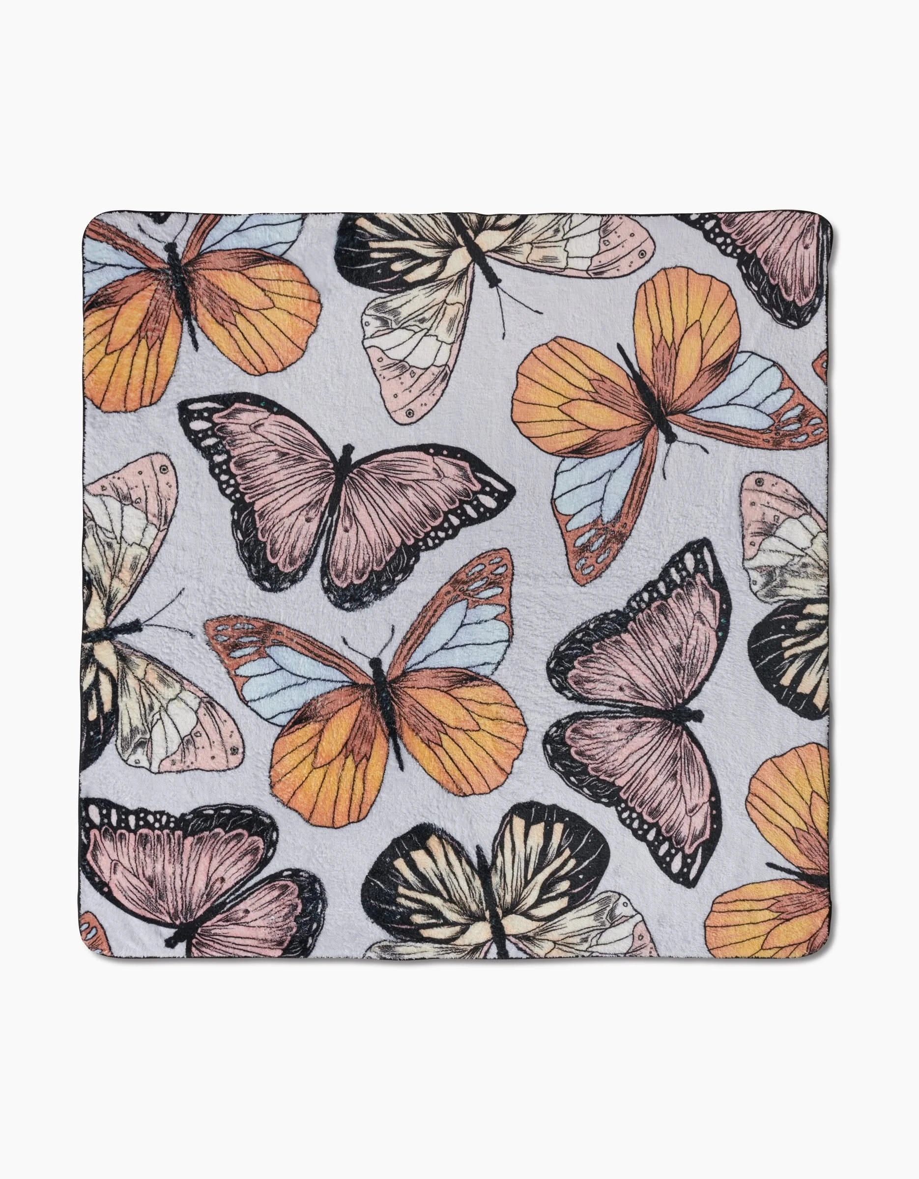 Geometry’s “Cute Butterflies” is a square recycled fabric featuring a colorful butterfly pattern in orange, yellow, pink, and black on a light gray background.