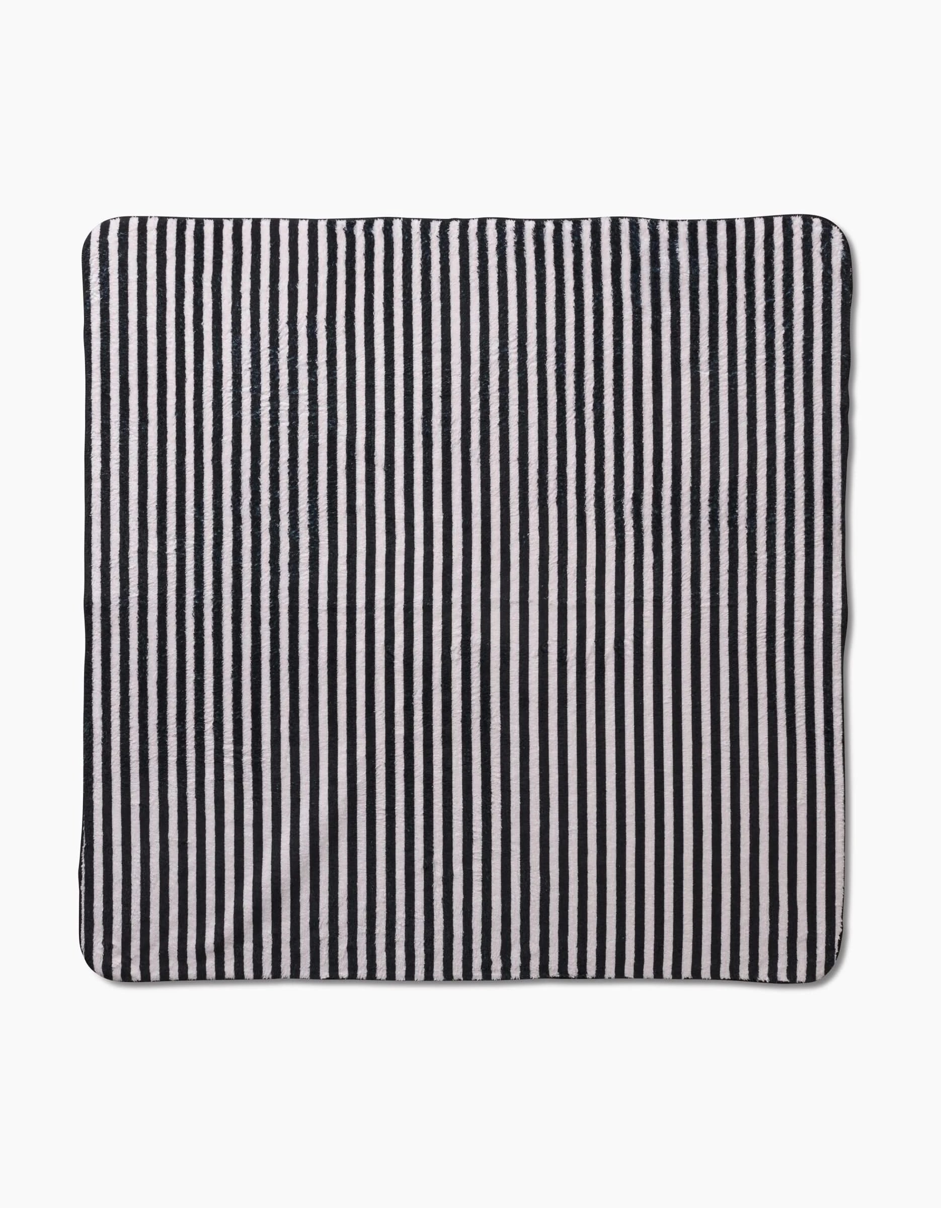 The Geometry Good Pup is a square cloth with black and white vertical stripes, made from recycled materials, shown laid flat on a white background.