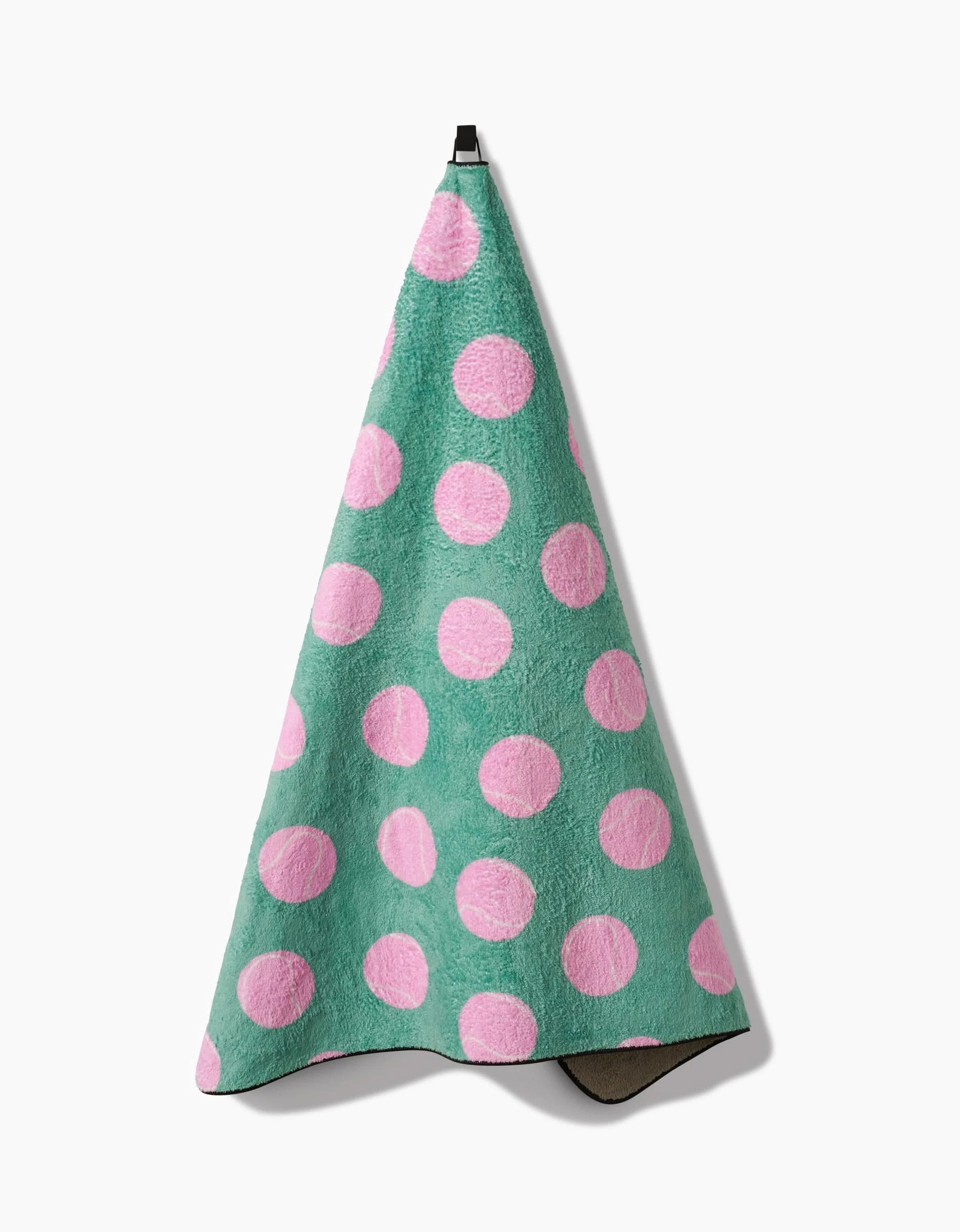 A Geometry Pink Ball dog towel, ultra-absorbent and featuring large pink polka dots, hangs from a hook against a white background.