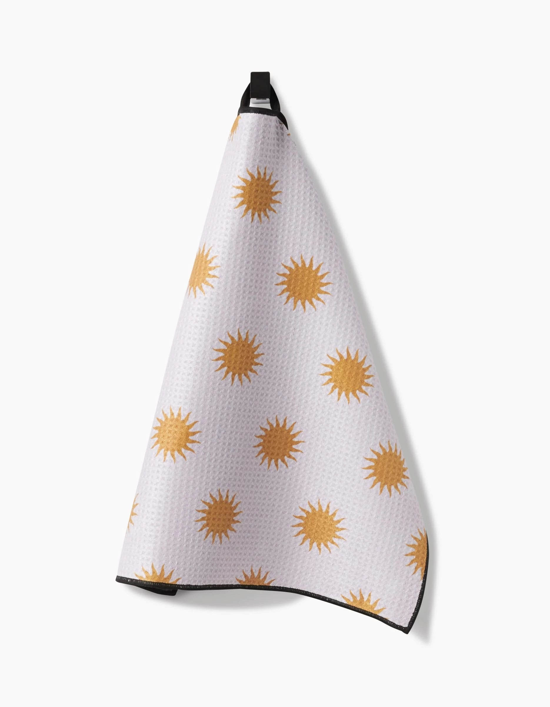 The Geometry Feeling Sunny towel, made from ultra-absorbent Geoweave fabric, features yellow sun shapes on a white background and hangs from a black loop.