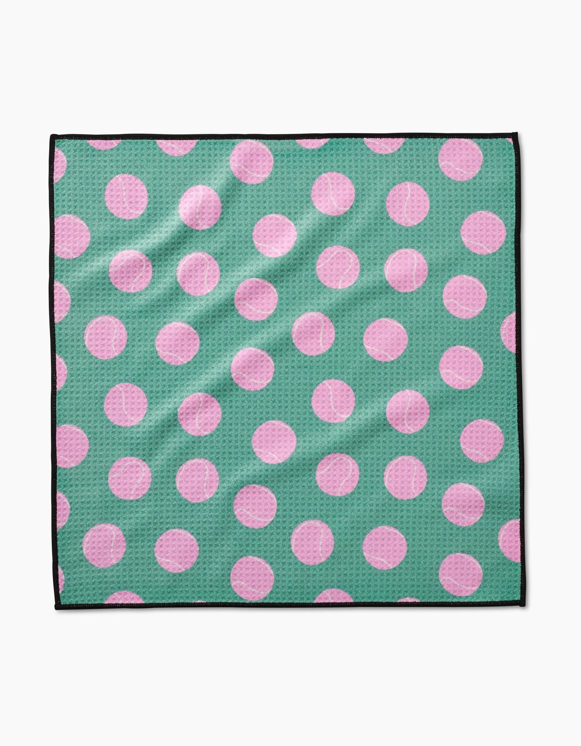 The Geometry Pink Ball is a square cloth made from ultra-absorbent Geoweave fabric, featuring large pink polka dots on a green background and a thin black edge.