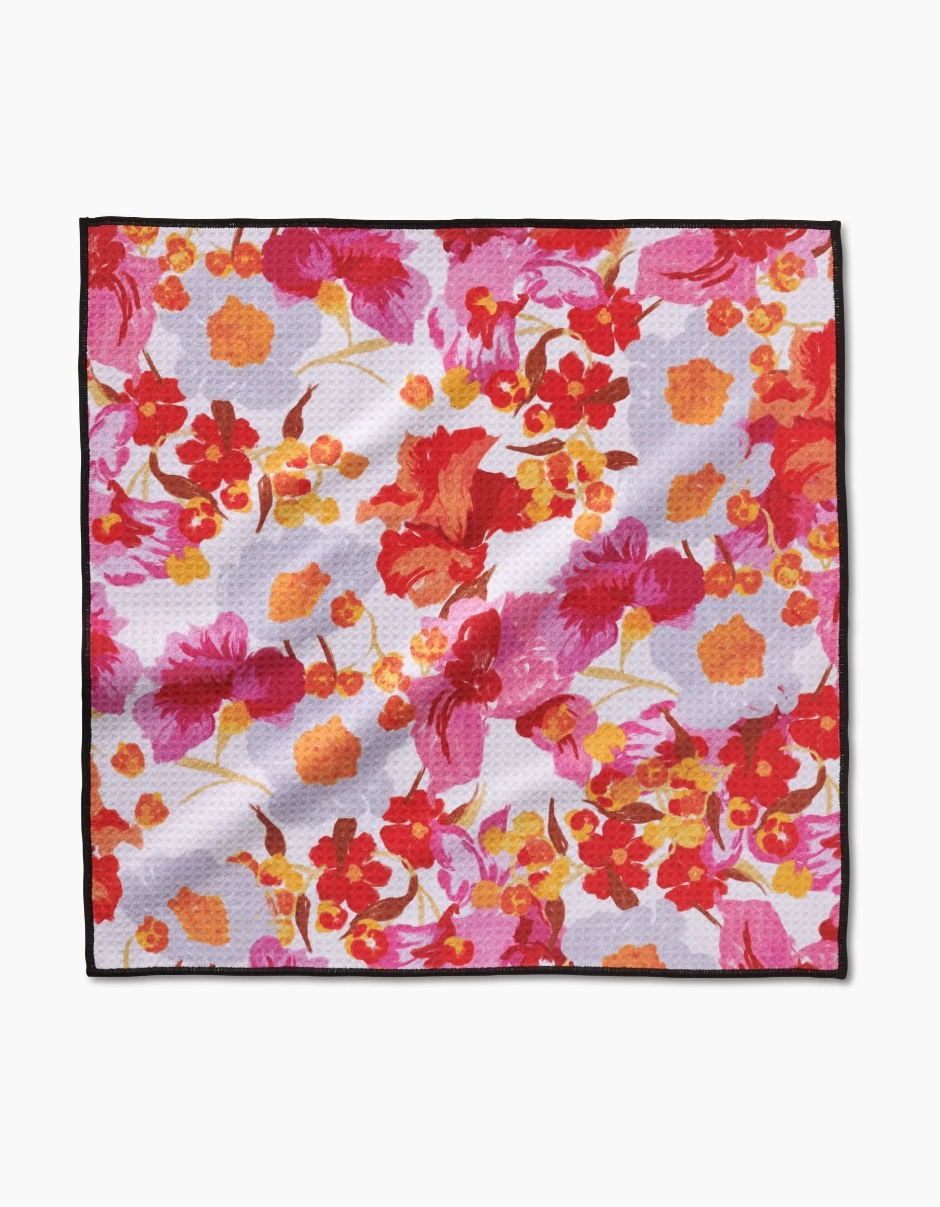 The Geometry Pup Florals Paw Towel features a vibrant floral pattern in red, pink, orange, and yellow on a light background, finished with a black border and made from ultra-absorbent Geoweave fabric.