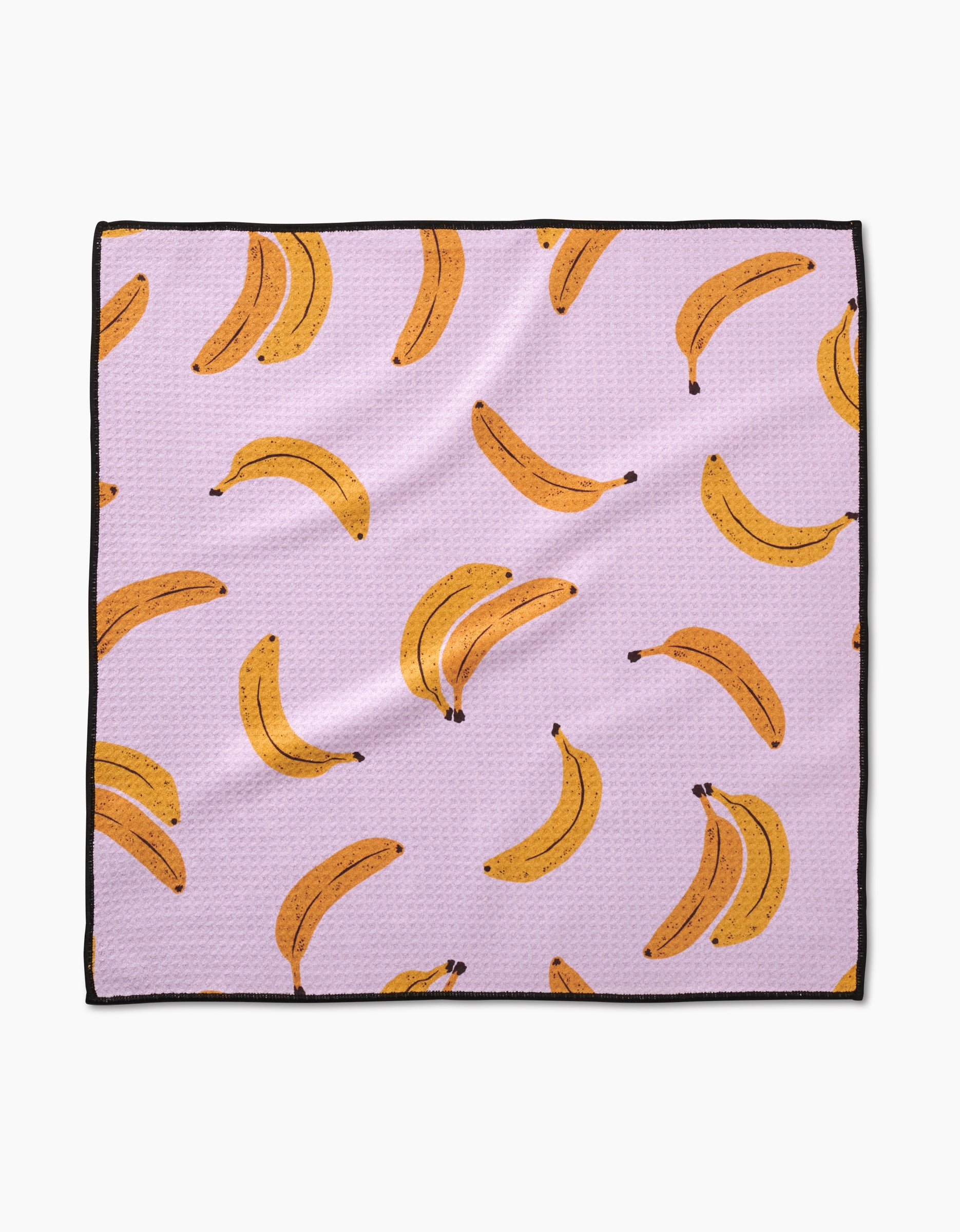 The Geometry Pupnana is a square Paw Towel with a light purple background, repeating yellow banana illustrations (single and in pairs), ultra-absorbent Geoweave fabric, and a sleek black border around the edges.