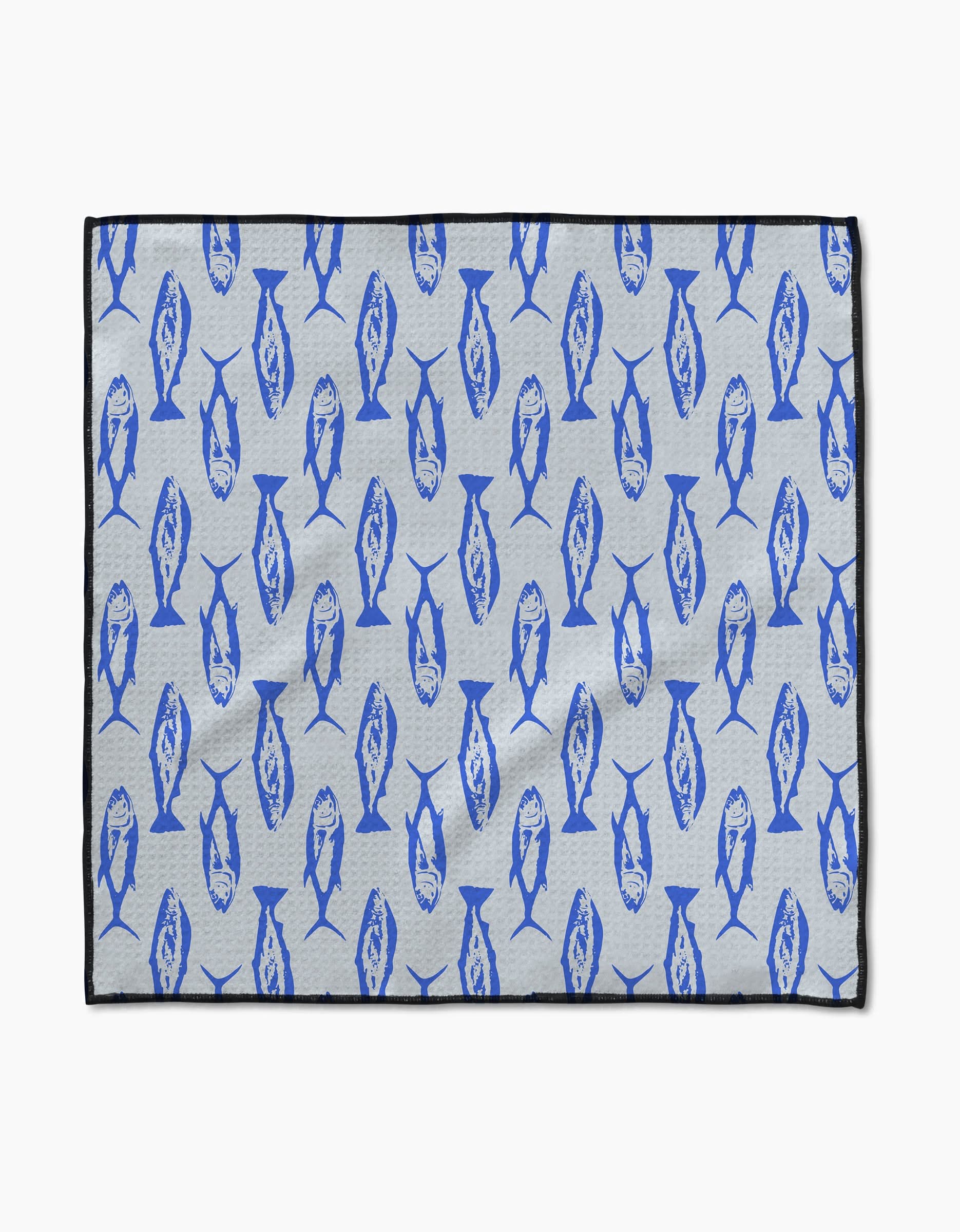 The Geometry Coastal Catch mat features a light gray background with blue fish in various directions, a thin black border, and is crafted from ultra-absorbent Geoweave fabric.