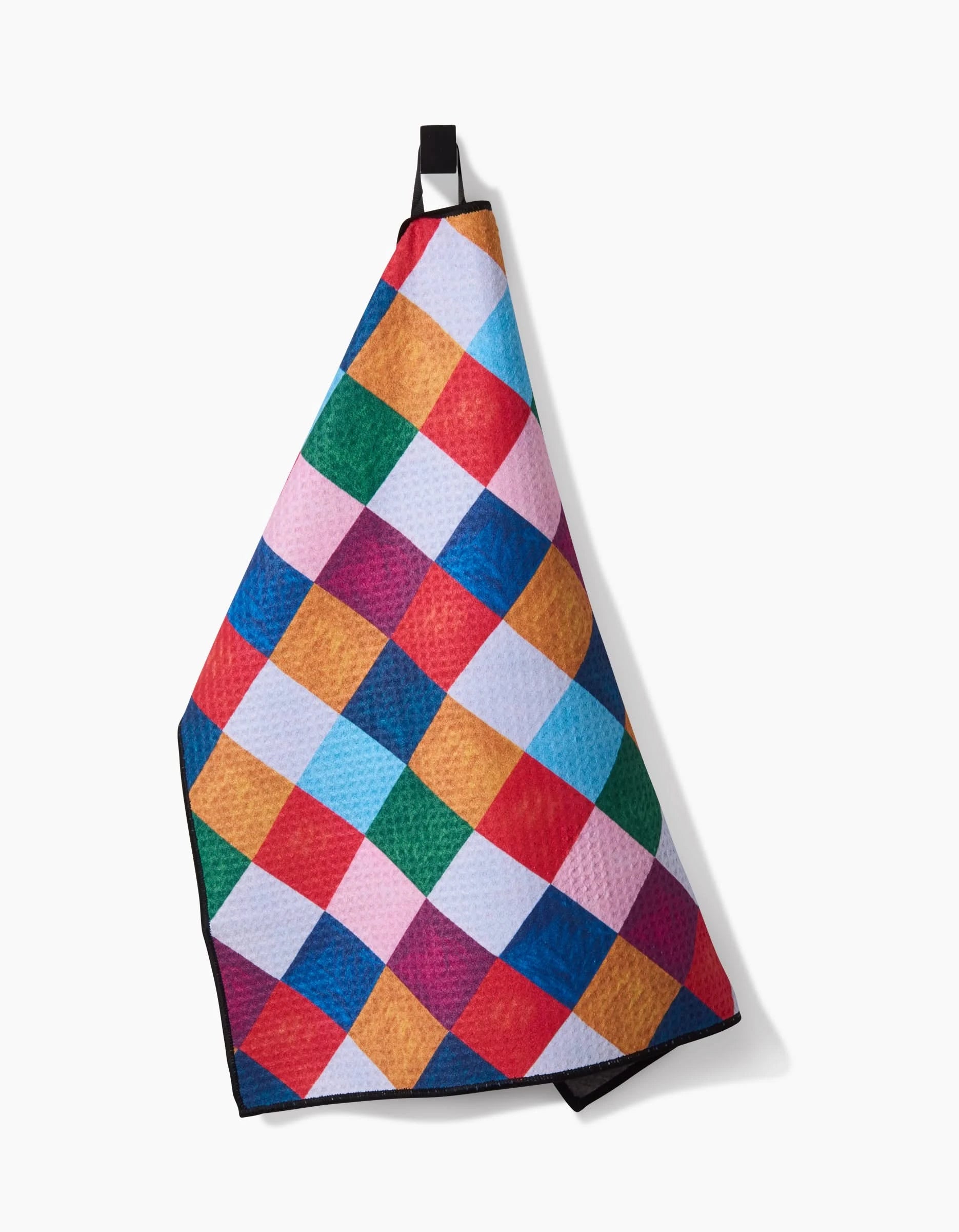The Daria Solak Holiday Harlequin towel features a vibrant diamond-checkered design and hangs by a black loop—perfect as an ultra-absorbent dog towel or recycled pet towel.