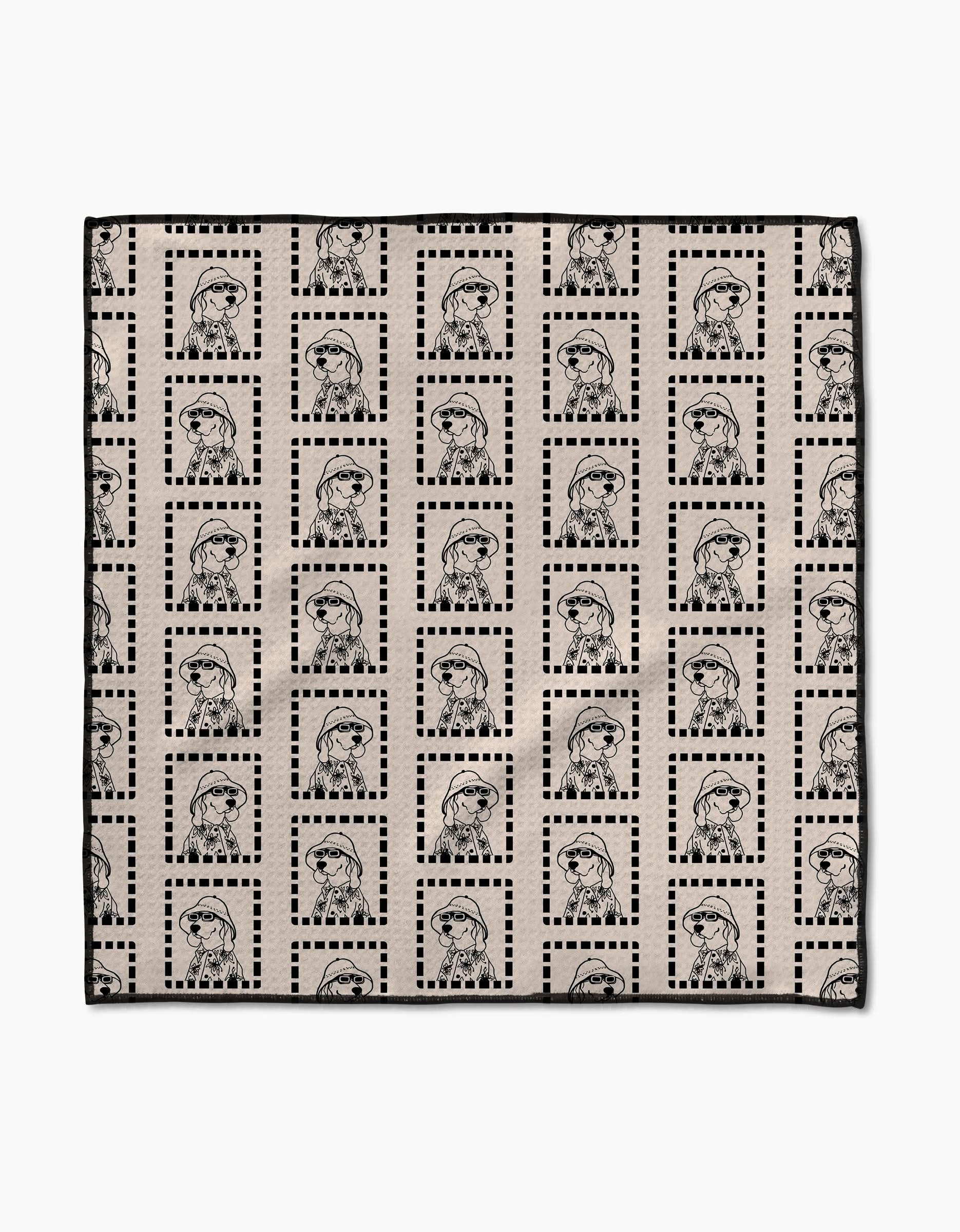 The Ready For Summer Doggy Paw Towel by Geometry features beige Geoweave fabric with a grid of dotted black squares and outlined figures in berets and jackets, combining stylish design with ultra-absorbent performance.