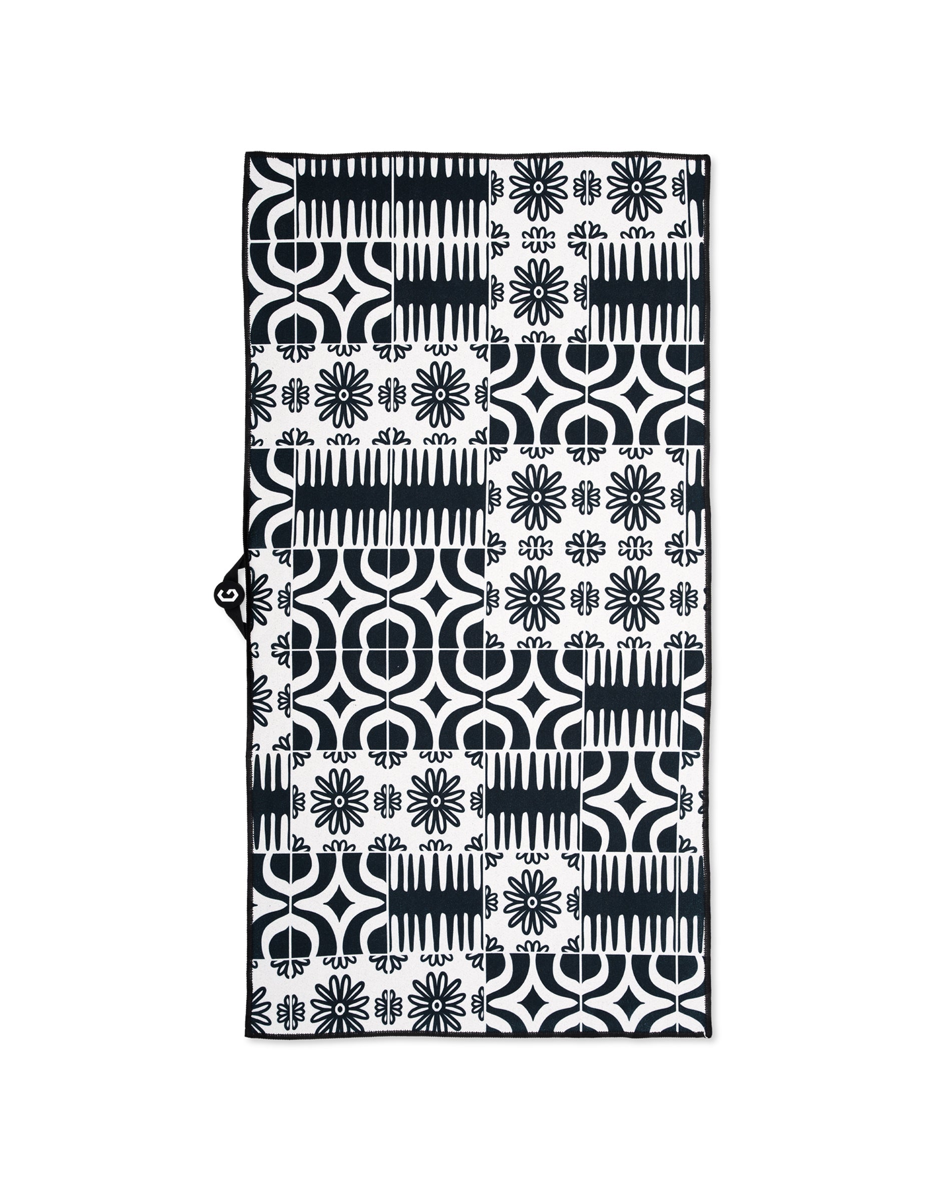 The GEOMETRY Magna - Bohemian Mosaic gym towel is rectangular and ultra-absorbent, featuring a black and white geometric and floral patchwork with circles, lines, and flower-like shapes.