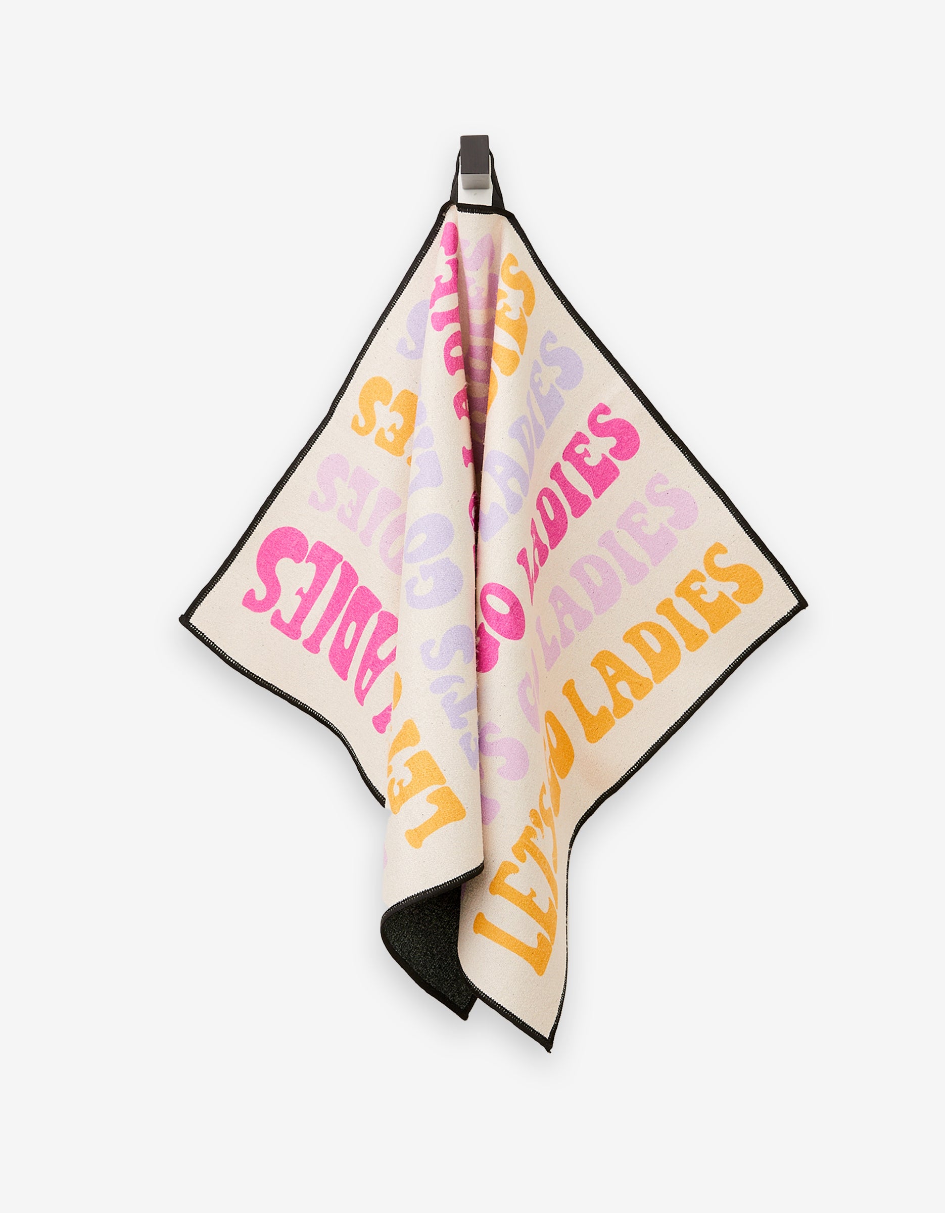A white GEOMETRY Ladies Only Fitness Towel, made from ultra-absorbent recycled materials with LEMON LADIES printed in pink, purple, and yellow, hangs from a black hook against a plain white background.