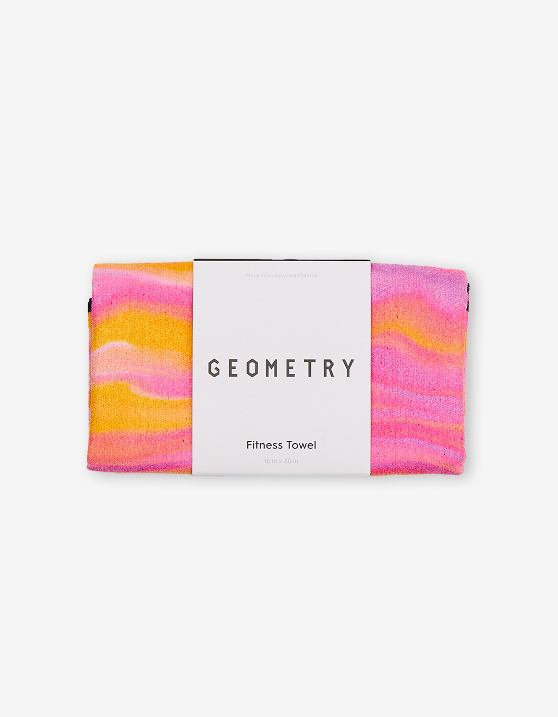 A folded, ultra-absorbent fitness towel called The Rush by GEOMETRY features a pink, orange, and yellow wavy pattern with a white “GEOMETRY Fitness Towel” label. Made from recycled materials. The background is plain white.