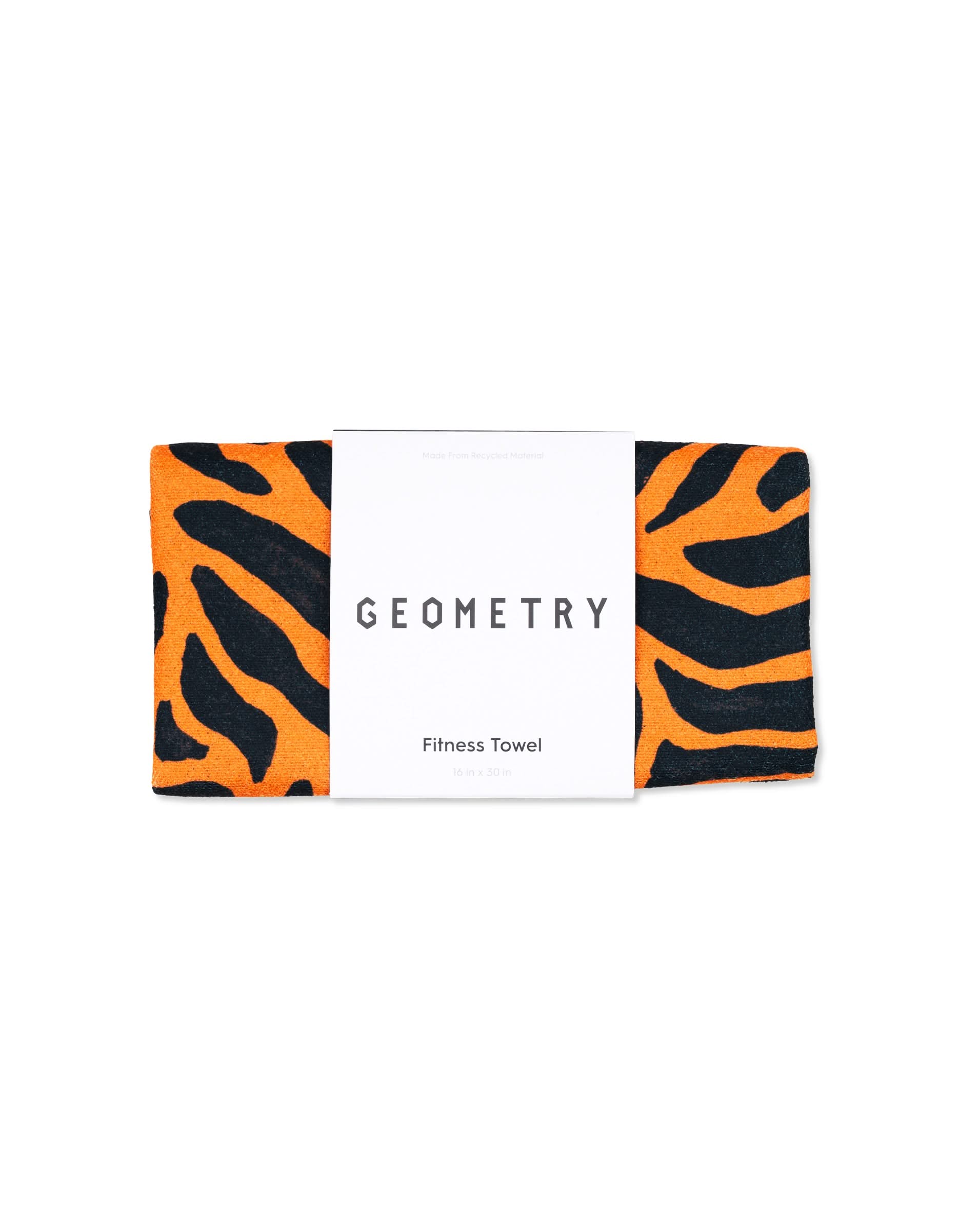 The Magna - Tiger Fitness Towel by GEOMETRY features bold orange and black tiger stripes, is ultra-absorbent, made from recycled materials, and comes with a white label displaying the brand name.