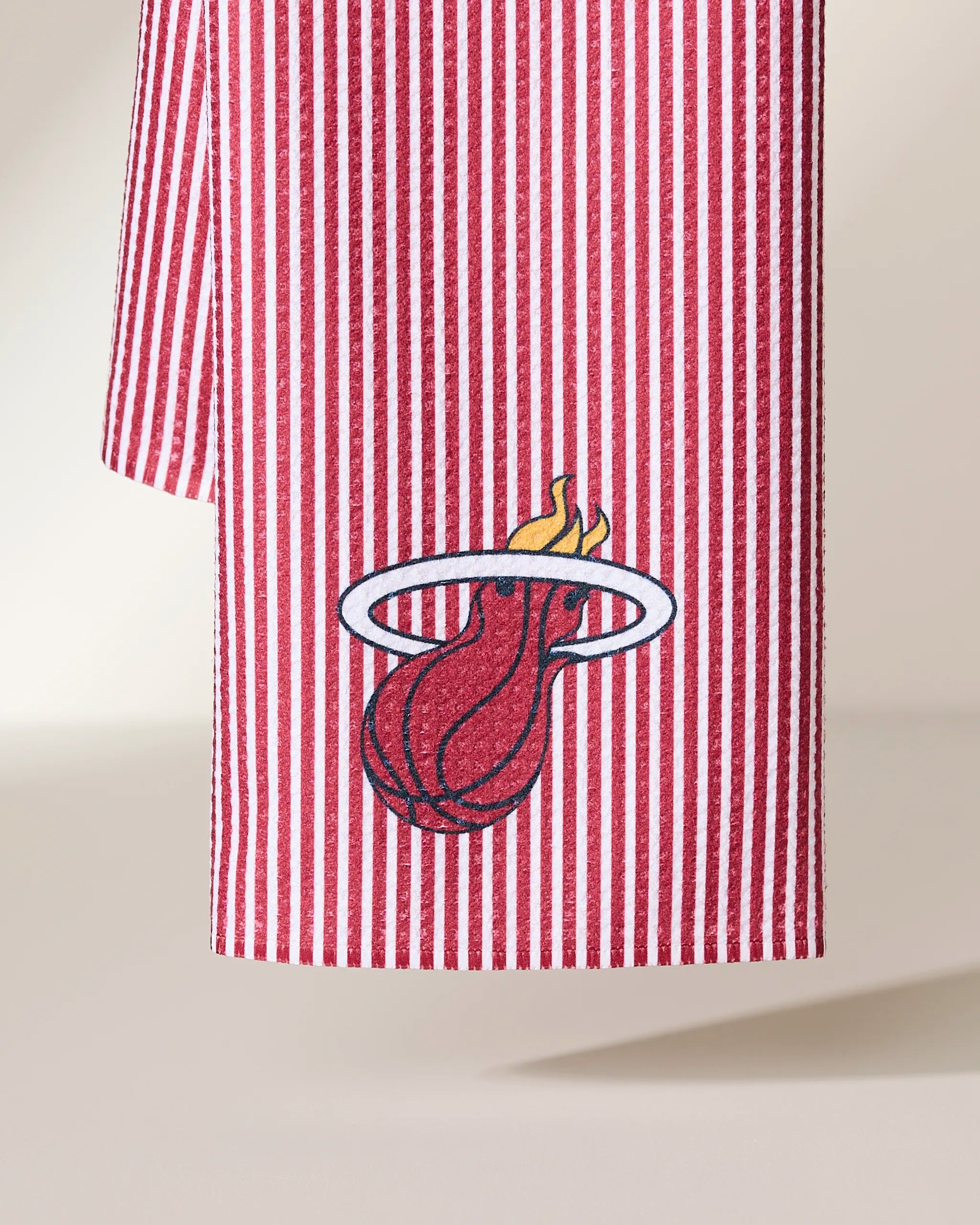 The Geometry Heat Classic features red and white vertical stripes with the Miami Heat logo—a flaming basketball through a white hoop—embroidered near the bottom.
