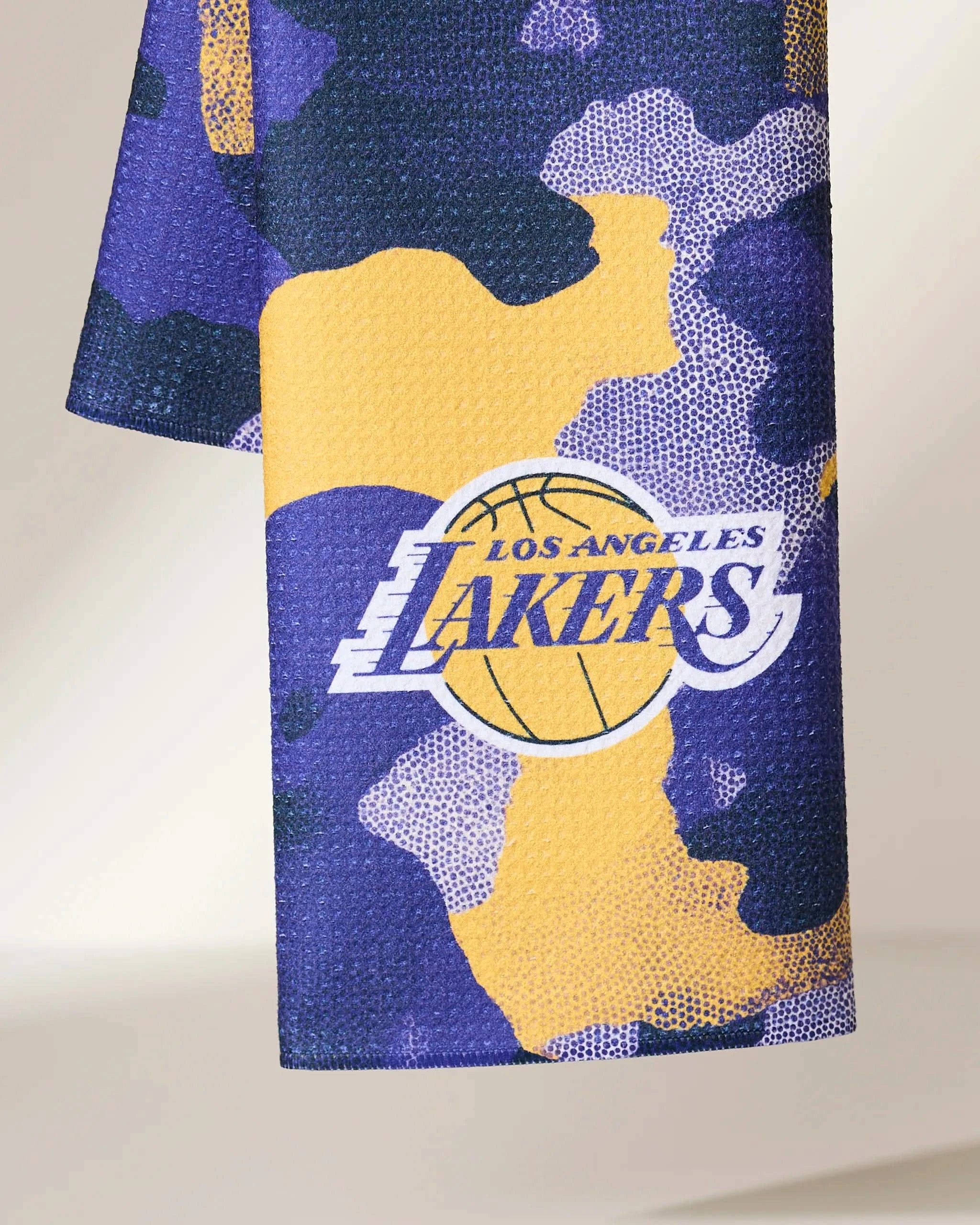 A close-up of the Geometry Lakers Camo fabric, showcasing a purple, yellow, and white camouflage pattern with the Los Angeles Lakers logo.