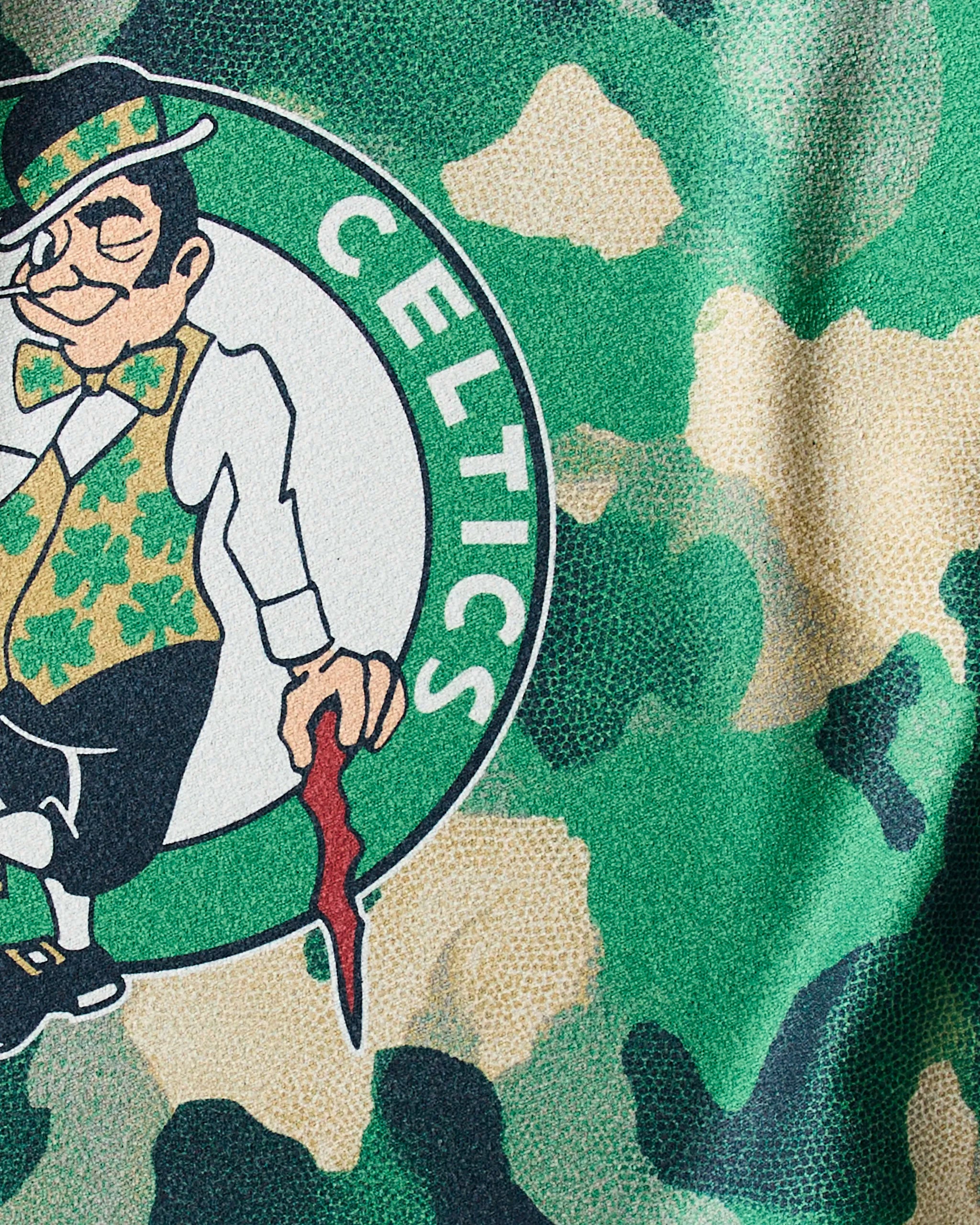 Show your team spirit during workouts with the Celtics Camo NBA fitness towel by Geometry, featuring a close-up of the Boston Celtics leprechaun logo set against a green camouflage-patterned background.