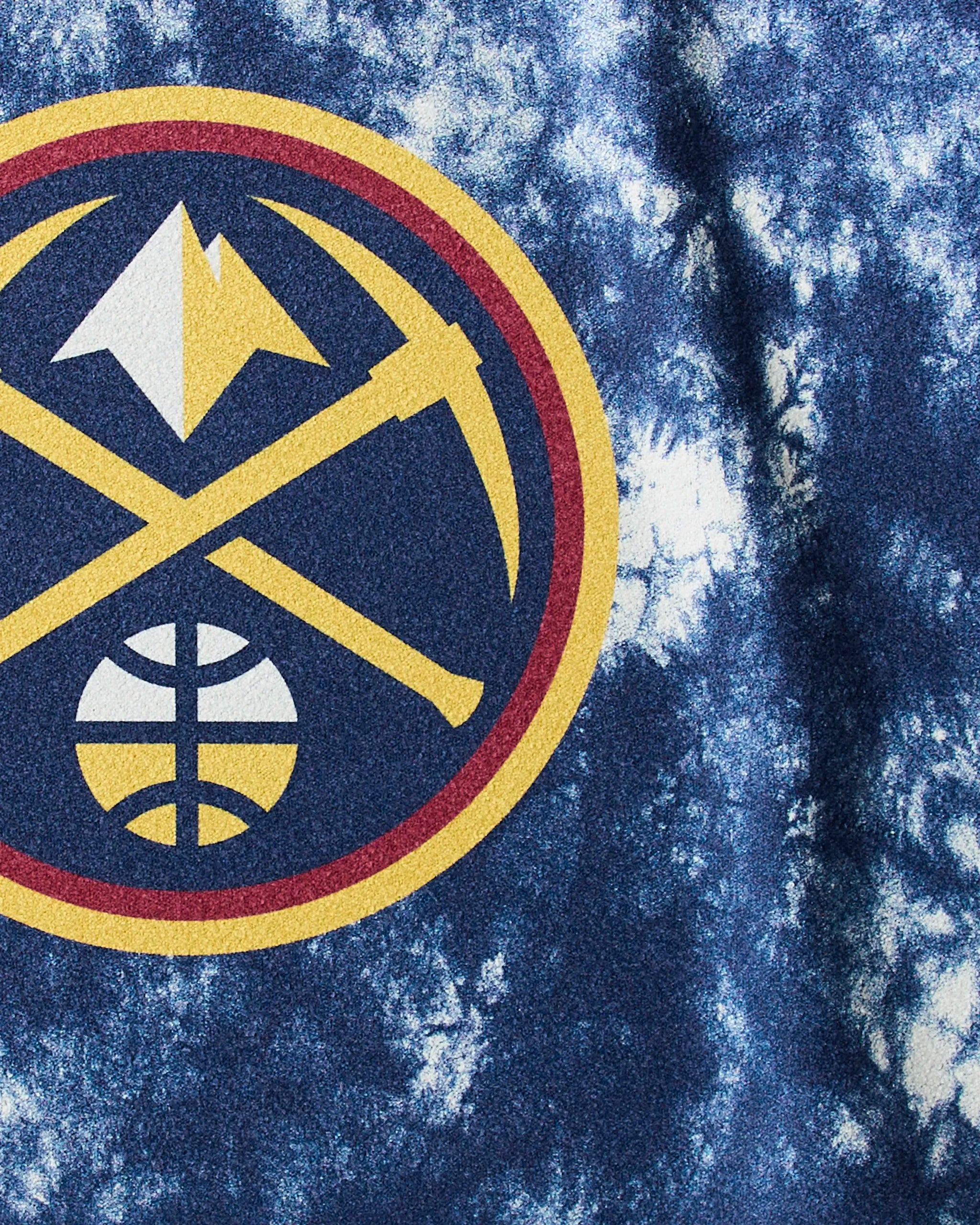 The Geometry Nuggets Flash fitness towel features a Denver Nuggets logo with two gold pickaxes, a white mountain, and a basketball in a red and gold circle on blue and white tie-dye—ideal for stylish fans at the gym.