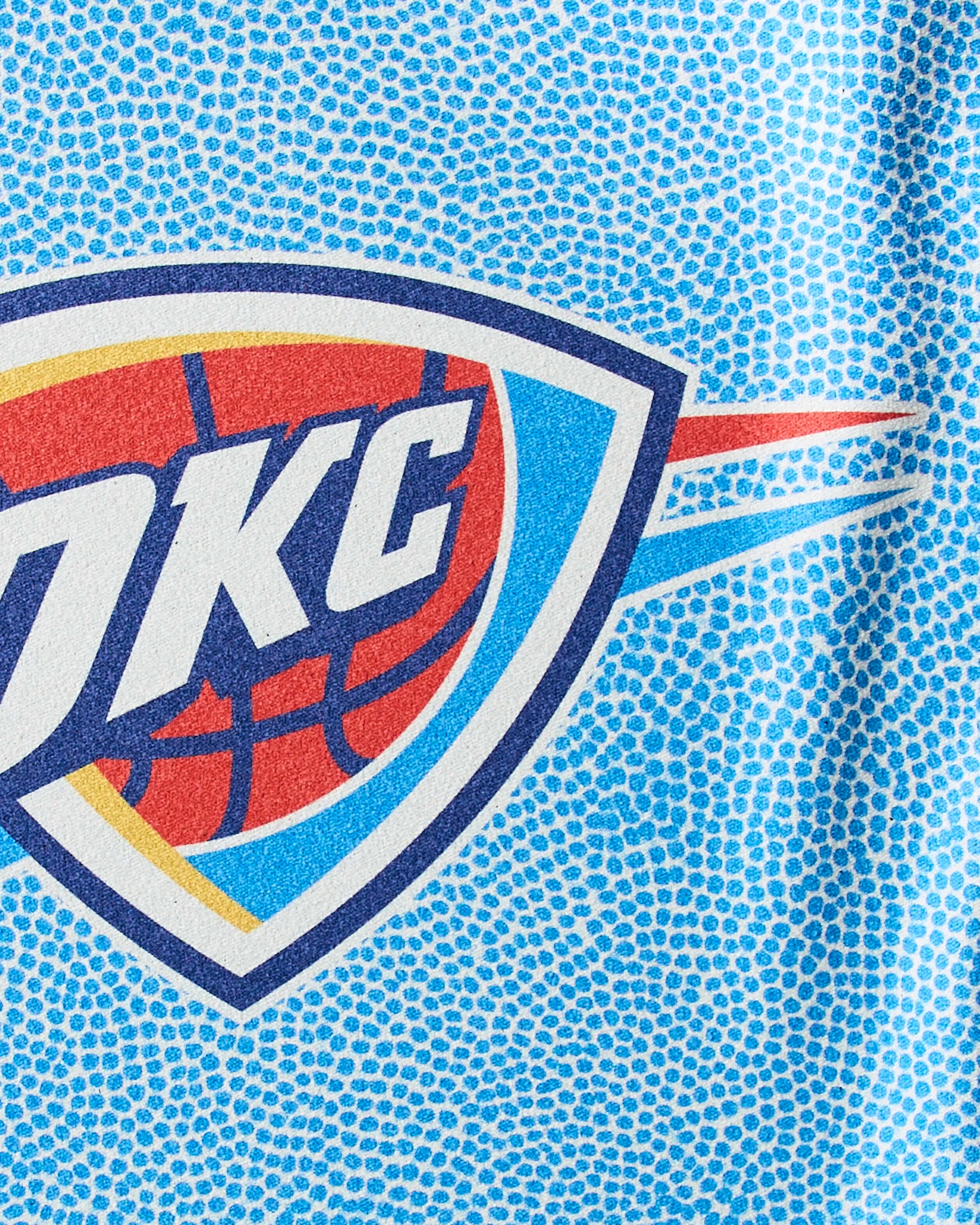 Close-up of the OKC Grip by Geometry, featuring the Oklahoma City Thunder logo on textured light blue Geoweave fabric—a sustainable workout towel ideal for NBA fans and fitness lovers.