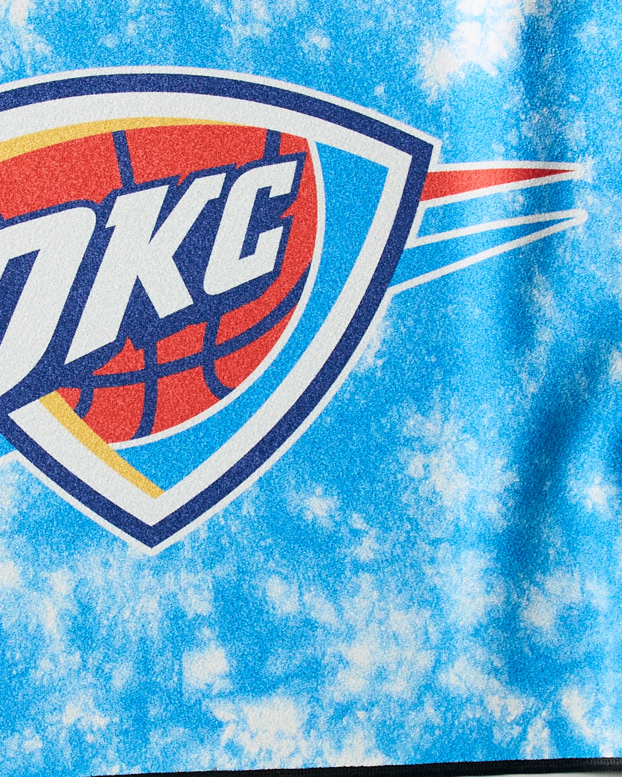 The image features the OKC Flash by Geometry, displaying the Oklahoma City Thunder logo with OKC letters above a basketball in blue, orange, and white on a textured blue background—ideal for an NBA fitness towel.