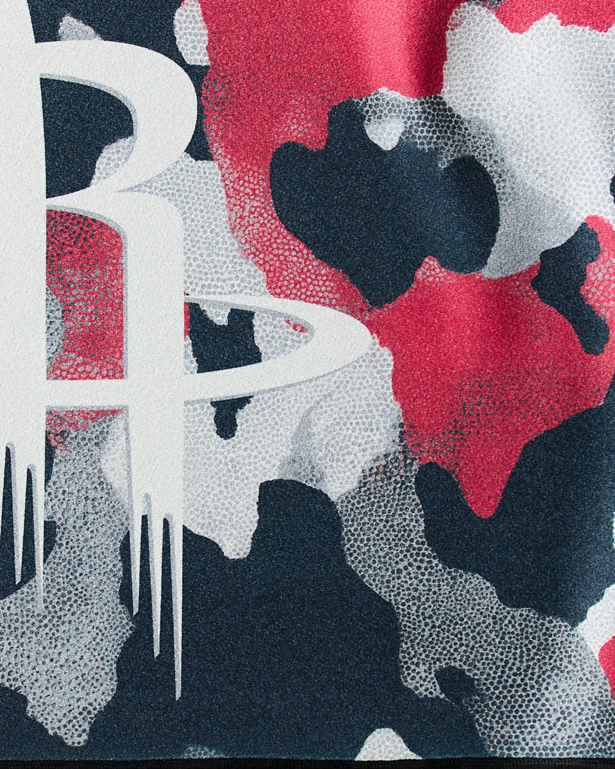 Abstract camo pattern in red, black, and white with a bold stylized "R" featuring ring and icicle-like drips—Rockets Camo by Geometry is perfect inspiration for a quick-drying gym towel design.