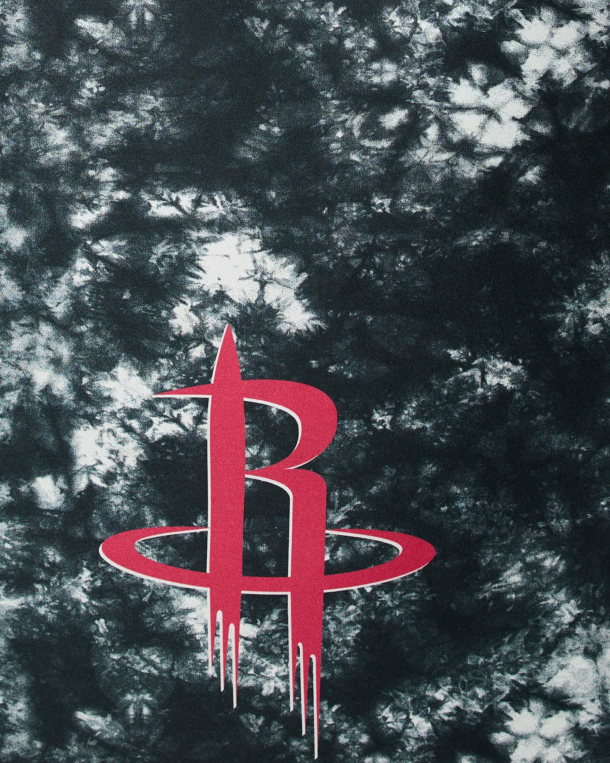 The image displays Geometry’s Rockets Flash: the Houston Rockets logo—a red stylized “R” with a ring at its base—against a black and white tie-dye textured background.