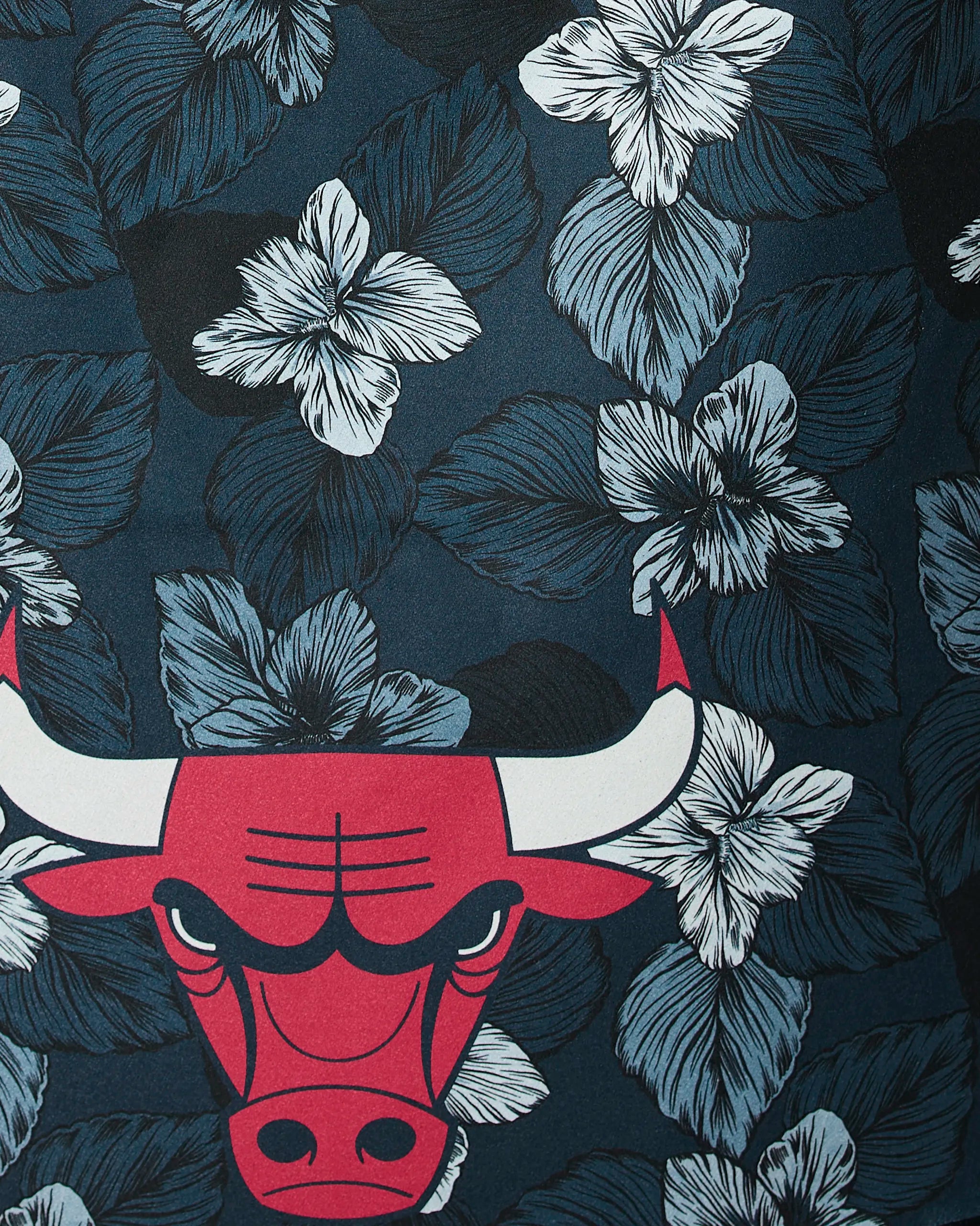 The Bulls Floral by Geometry features a red bulls head logo with white horns centered on a dark background, decorated with blue and white hibiscus flowers and leaves.