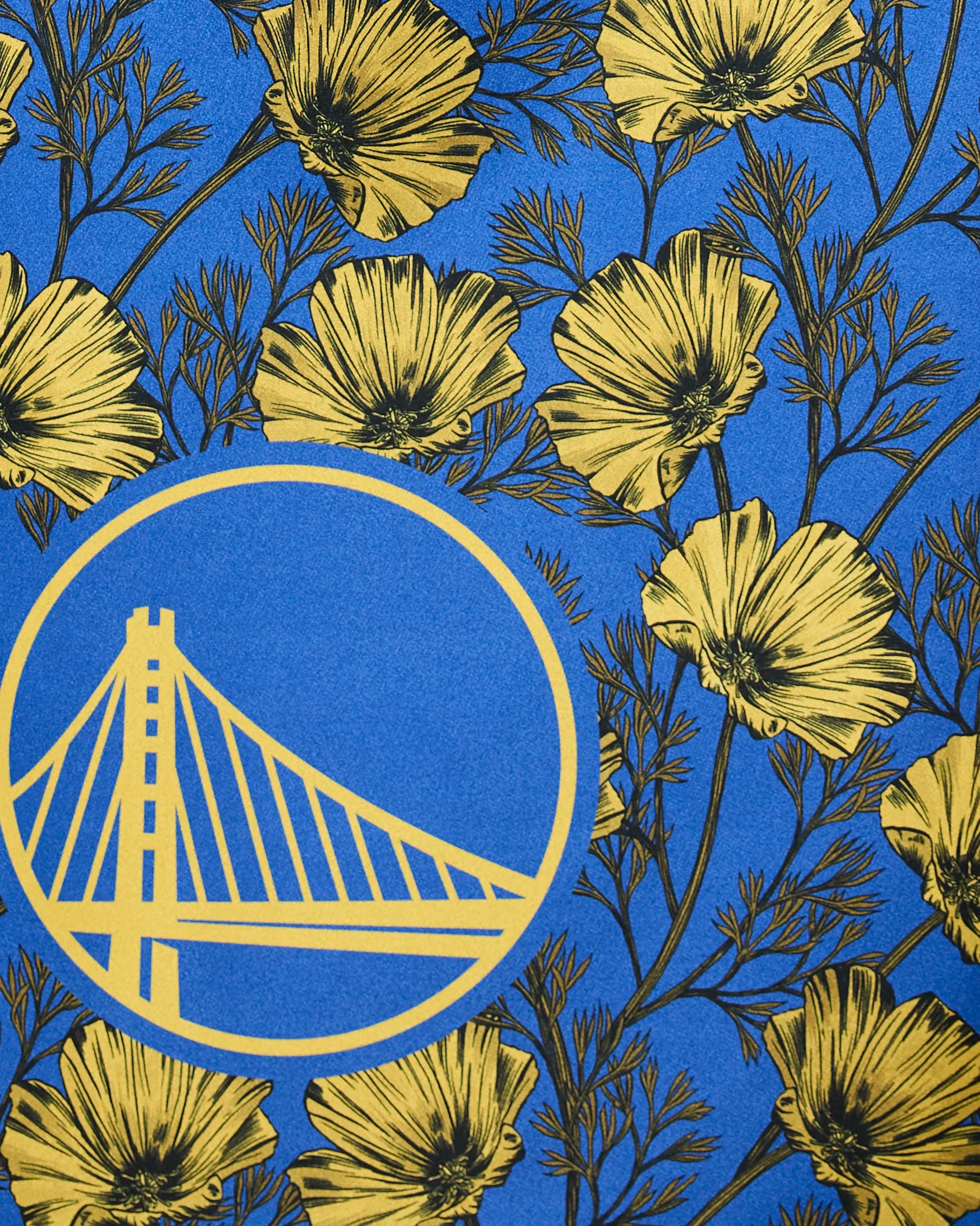 The Warriors Floral by Geometry showcases yellow poppy flowers and a stylized yellow suspension bridge emblem on a blue background.