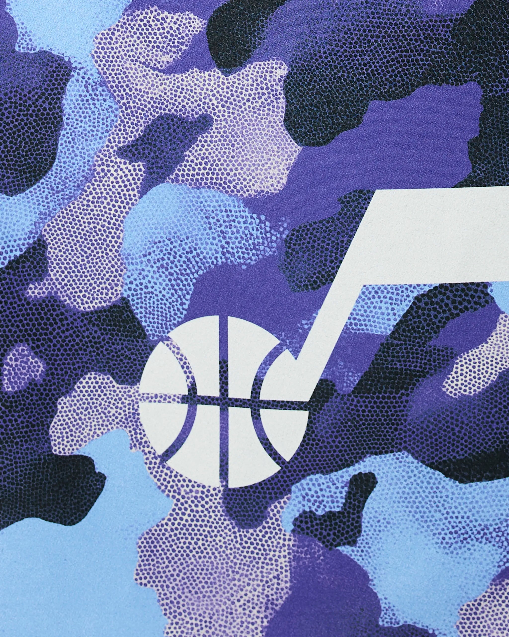 A close-up of Geometry’s Jazz Camo shows a blue, purple, and black camouflage pattern with white basketballs and musical notes overlayed.