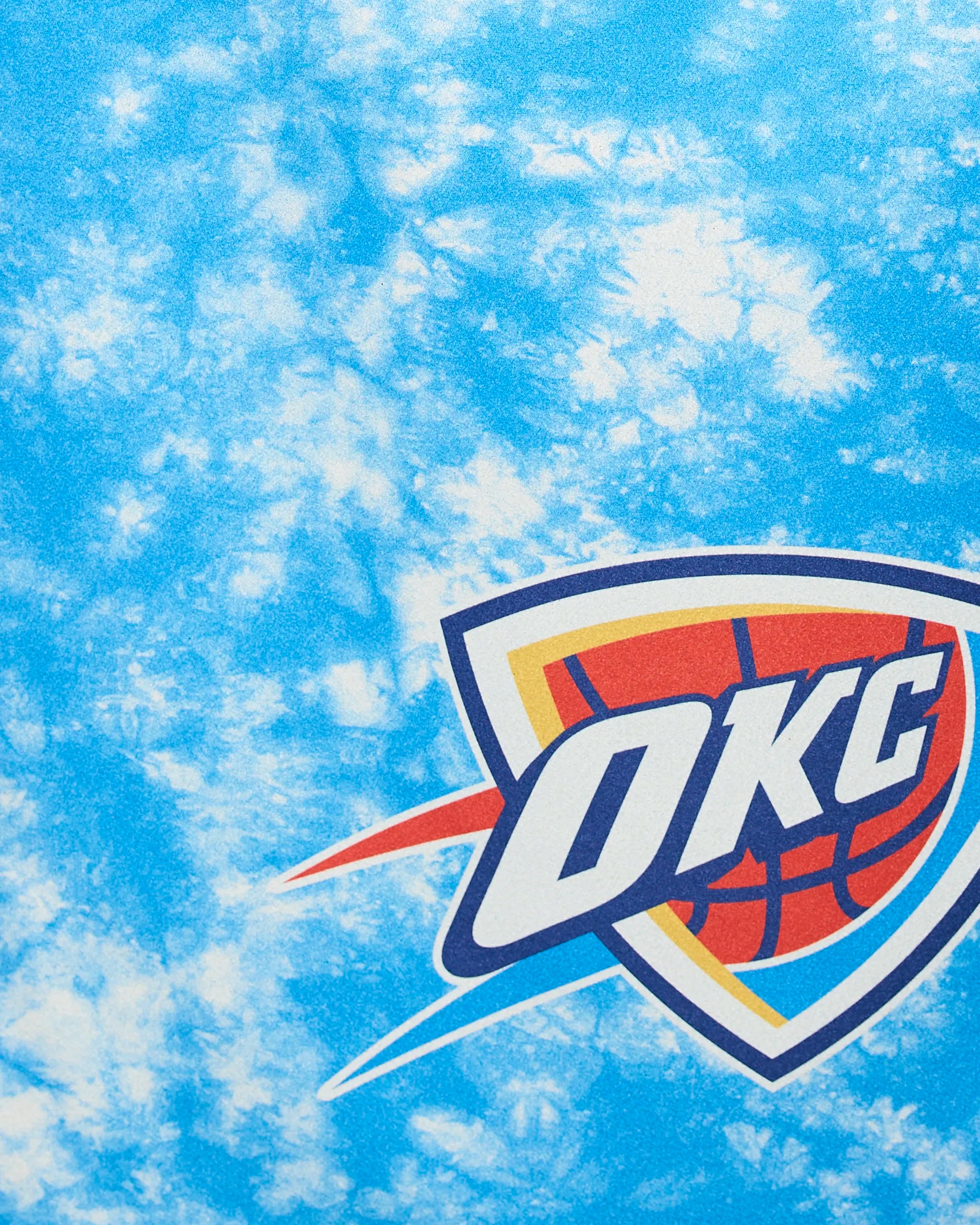 The image displays the OKC Flash logo by Geometry: bold OKC letters over a basketball, highlighted with an orange, blue, and yellow shield outline, set against a blue and white marbled background.