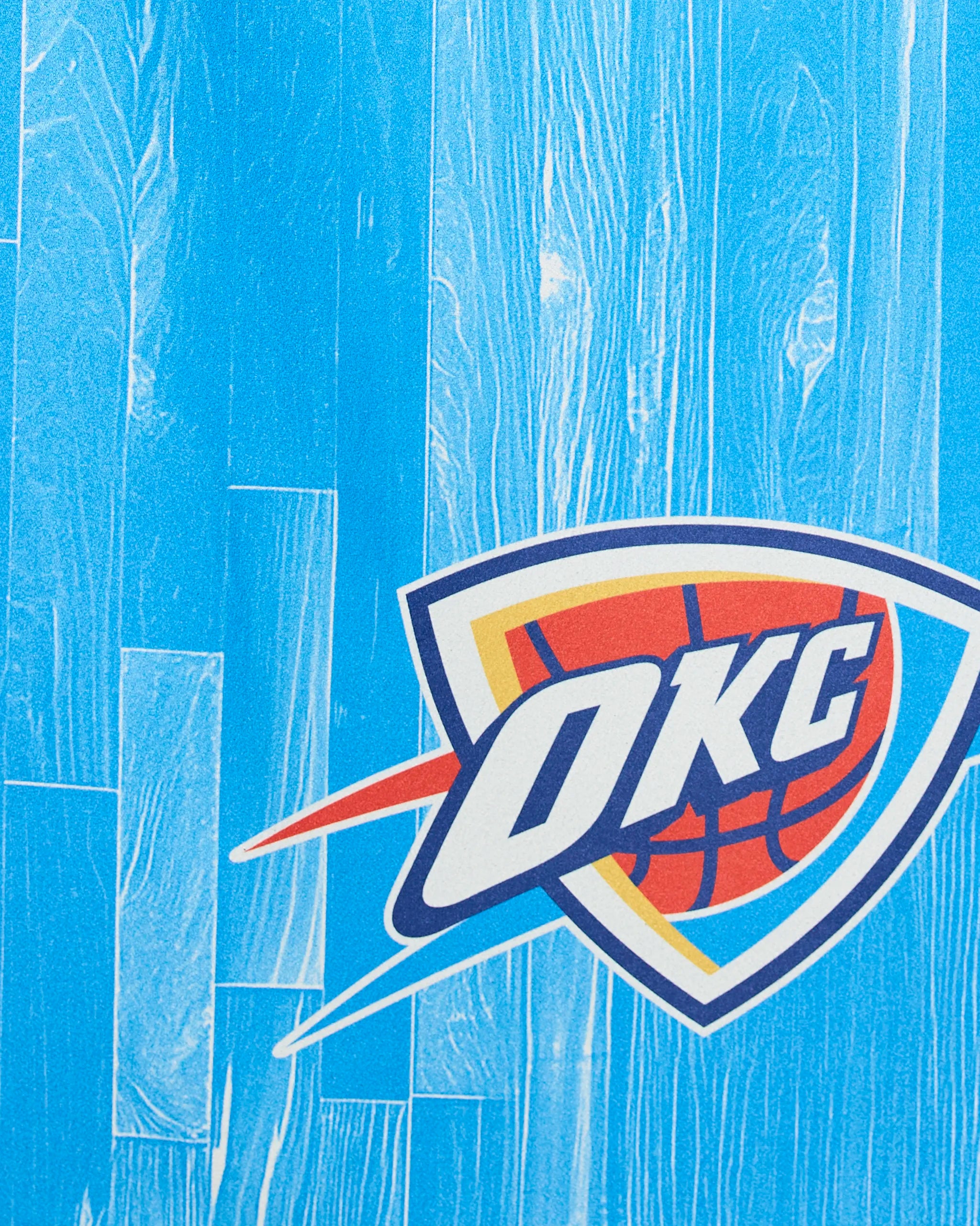 The OKC Zone by Geometry features the Oklahoma City Thunder basketball team logo on a vibrant blue wood-patterned background.