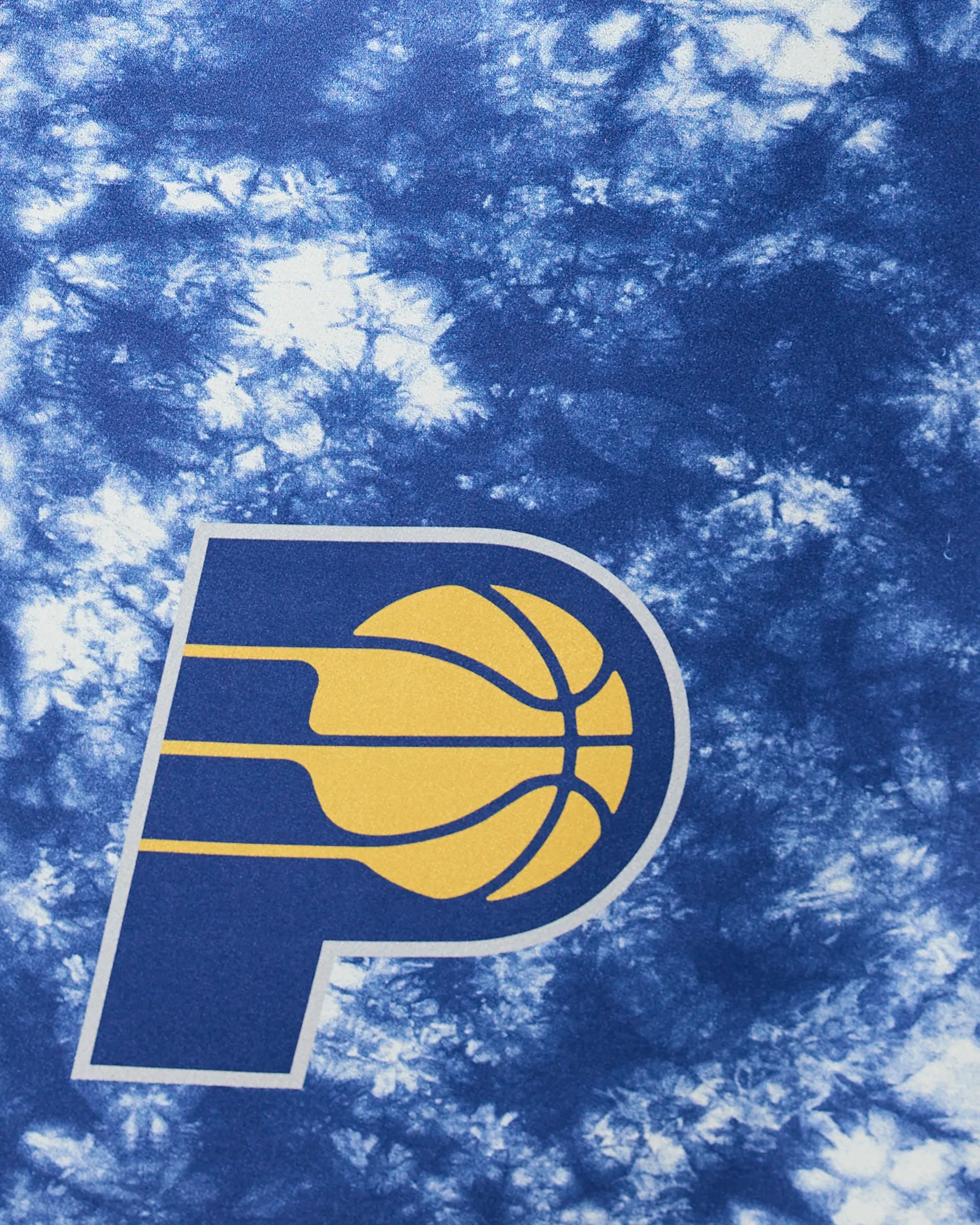 The image shows the Pacers Flash by Geometry, featuring the Indiana Pacers logo—a yellow basketball inside a blue P—on a blue and white tie-dye background.
