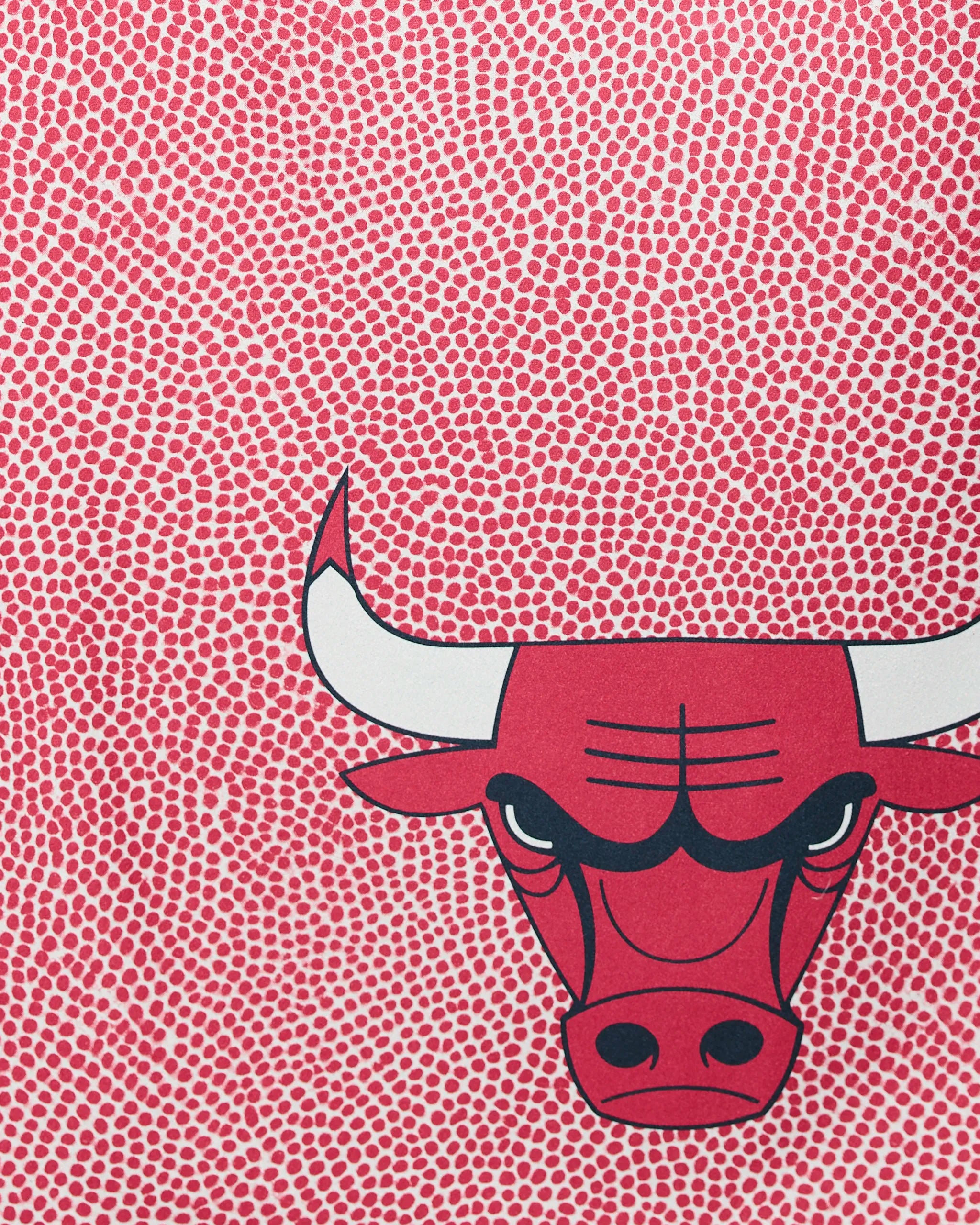 The Bulls Grip by Geometry features a stylized red bulls head with white horns set against a backdrop of dense, small red dots on a white surface.