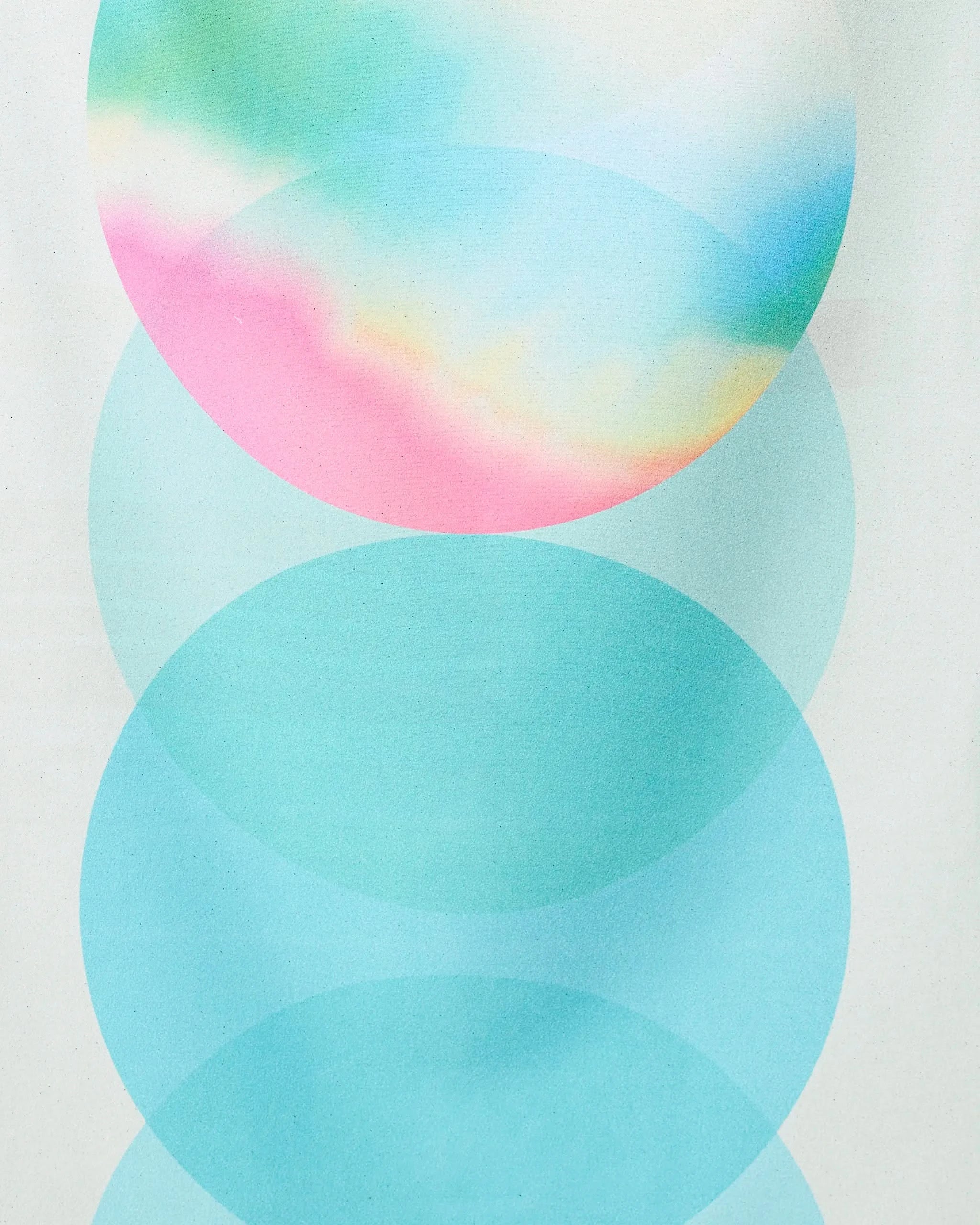 Three overlapping translucent circles on white; the top features pastel blue, pink, yellow, and green—reflecting the vibrant hues of GEOMETRY’s Green Dream quick-drying micro-loop beach towel made from recycled materials. The lower two are light blue and semi-transparent.