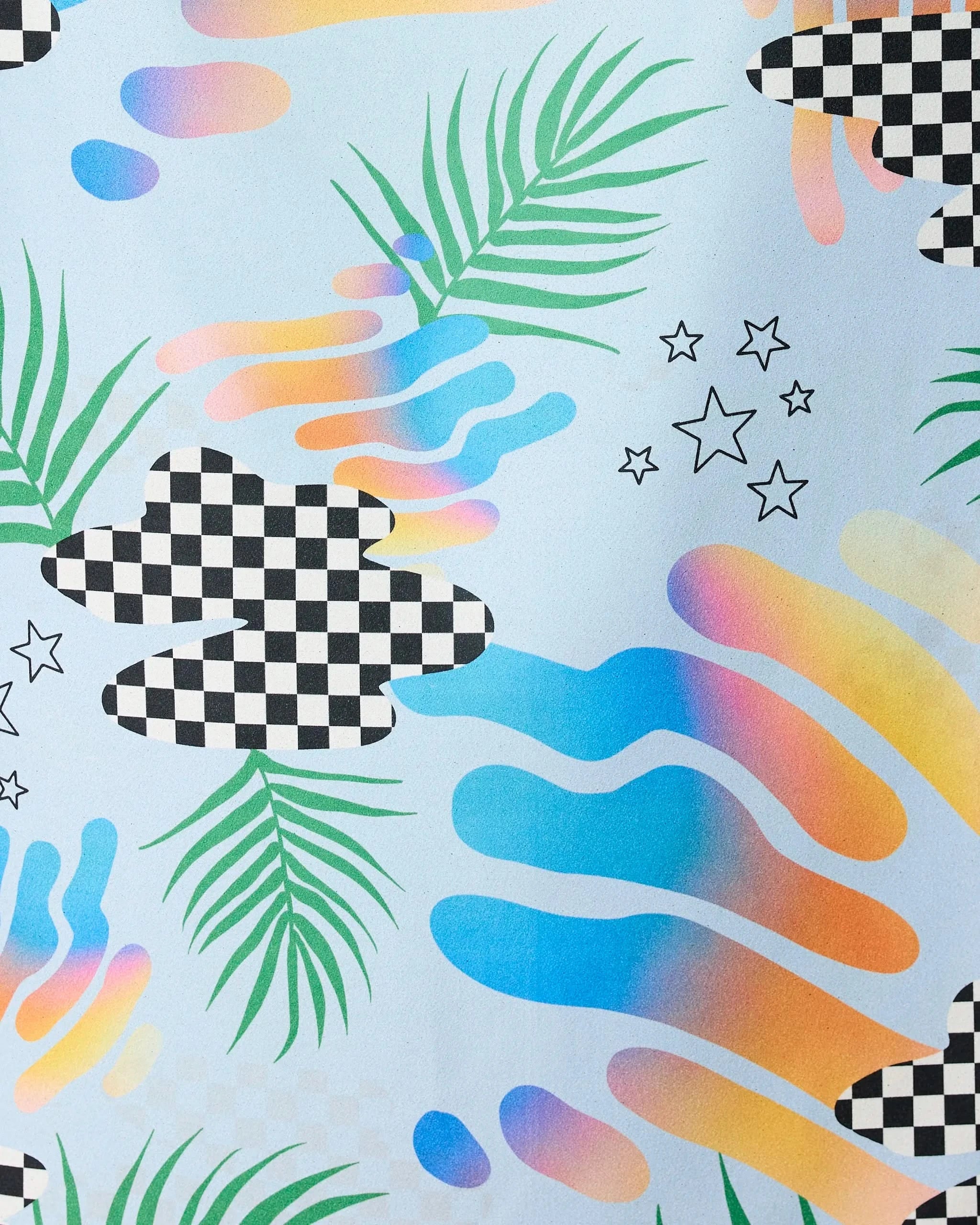 Abstract design with checkered clouds, gradient blobs, green palm leaves, and star outlines on a light background. The Playful Paradise Beach Towel by GEOMETRY combines pastel style and geometric shapes for a vibrant look.