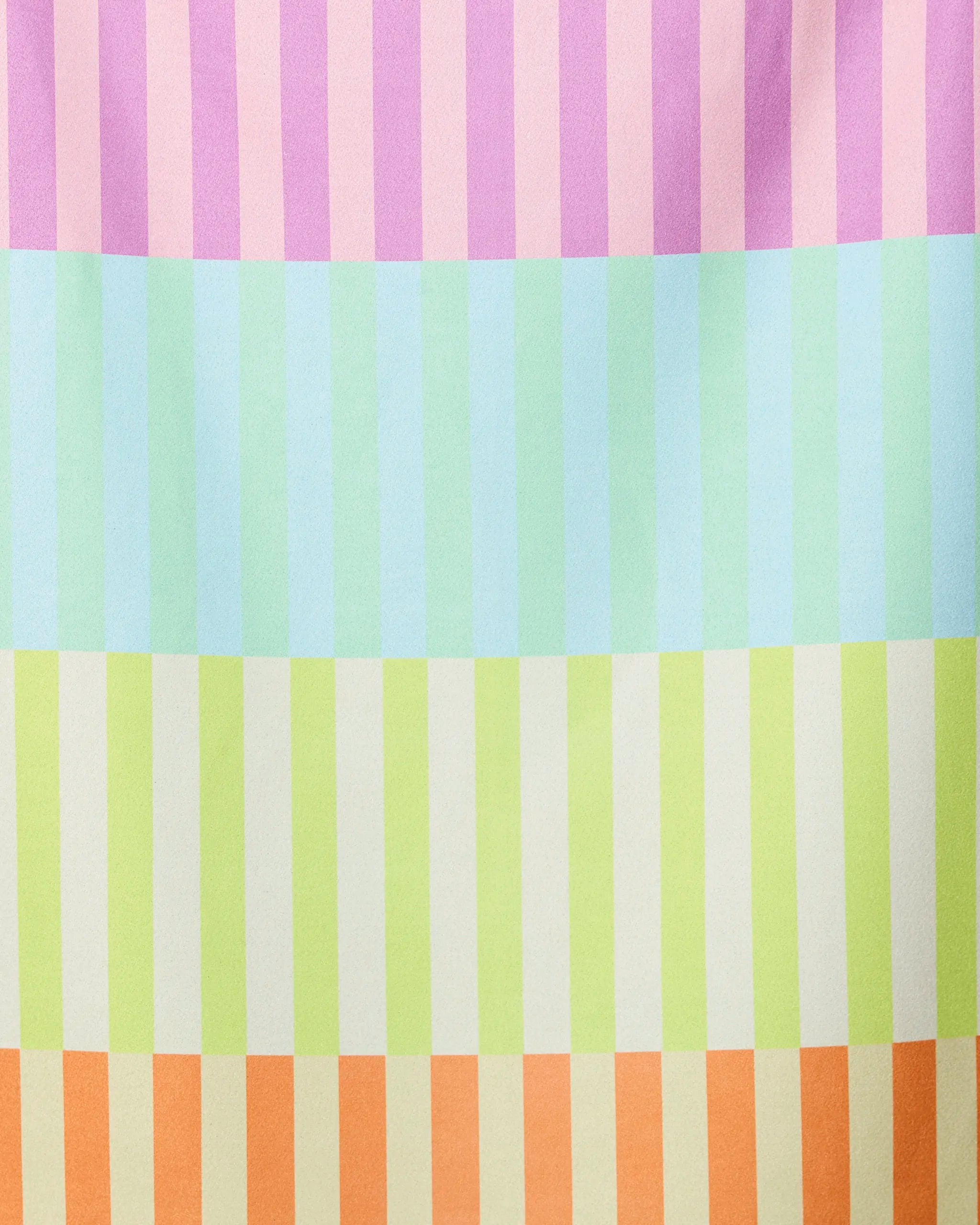 The GEOMETRY Neon Nights Micro-loop Beach Towel features vertical pastel stripes in vibrant pink, purple, mint green, blue, yellow, and beige. Quick-drying and made from recycled materials for a soft feel and playful style.