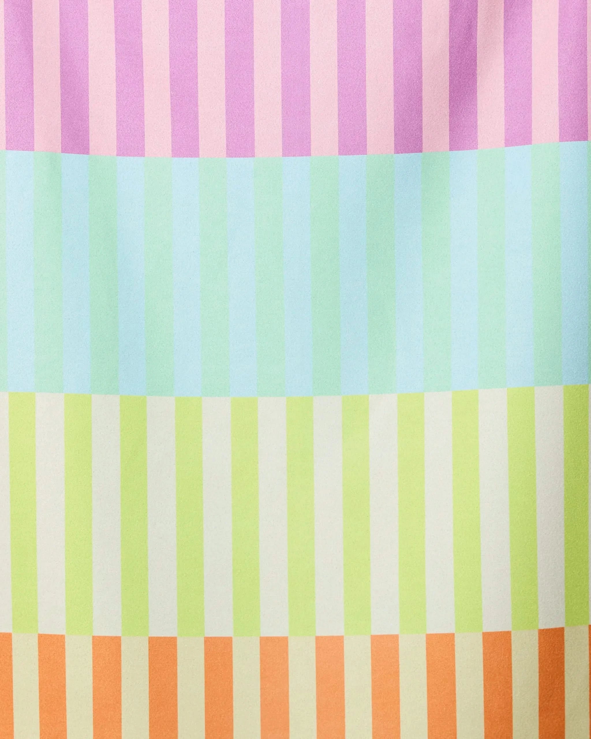 The GEOMETRY Neon Nights Micro-loop Beach Towel features vertical pastel stripes in vibrant pink, purple, mint green, blue, yellow, and beige. Quick-drying and made from recycled materials for a soft feel and playful style.