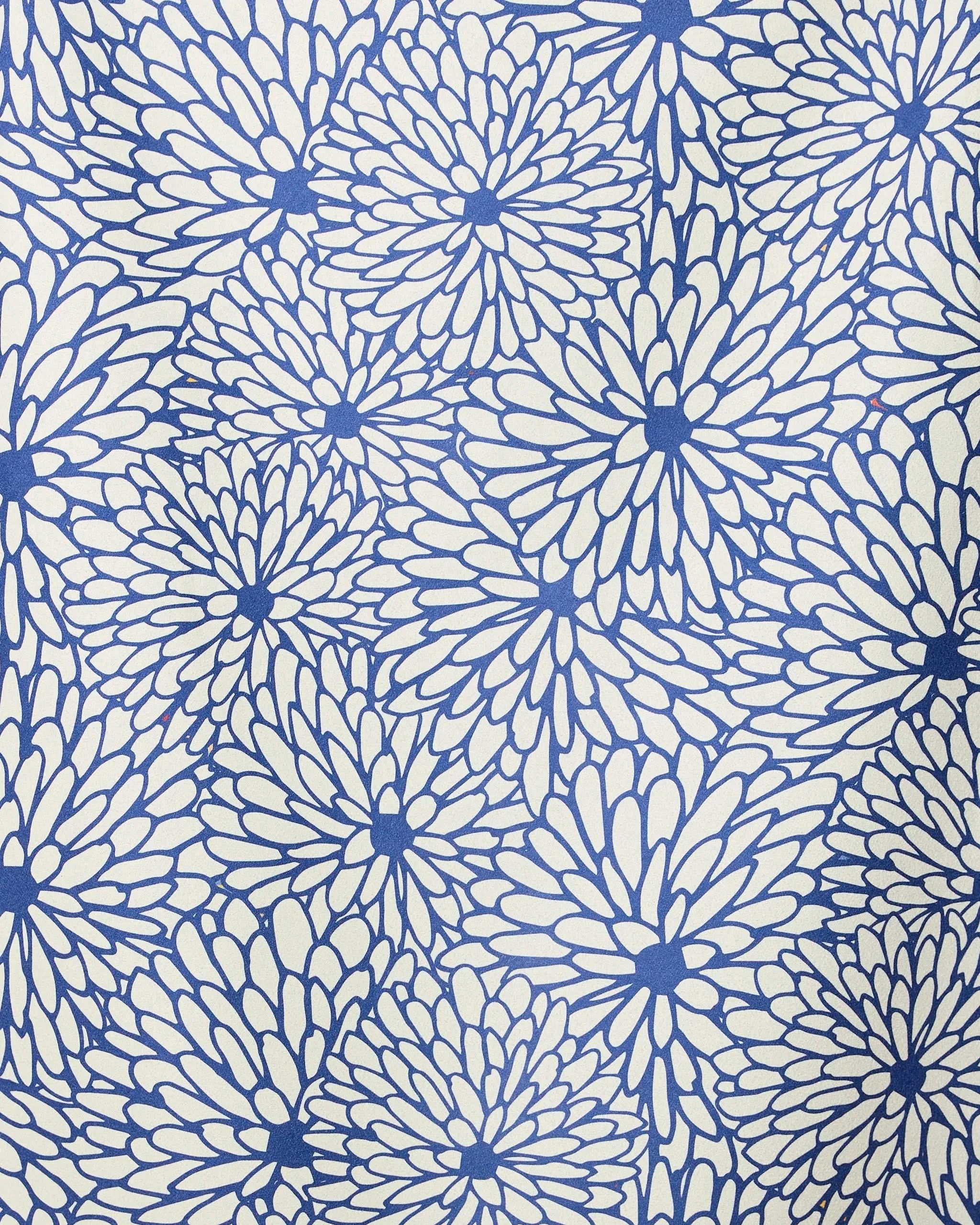 The GEOMETRY Jar Jar beach towel features dense blue flower-like patterns on a cream background, blending style and quick-drying function—ideal for stylish, practical days by the shore.
