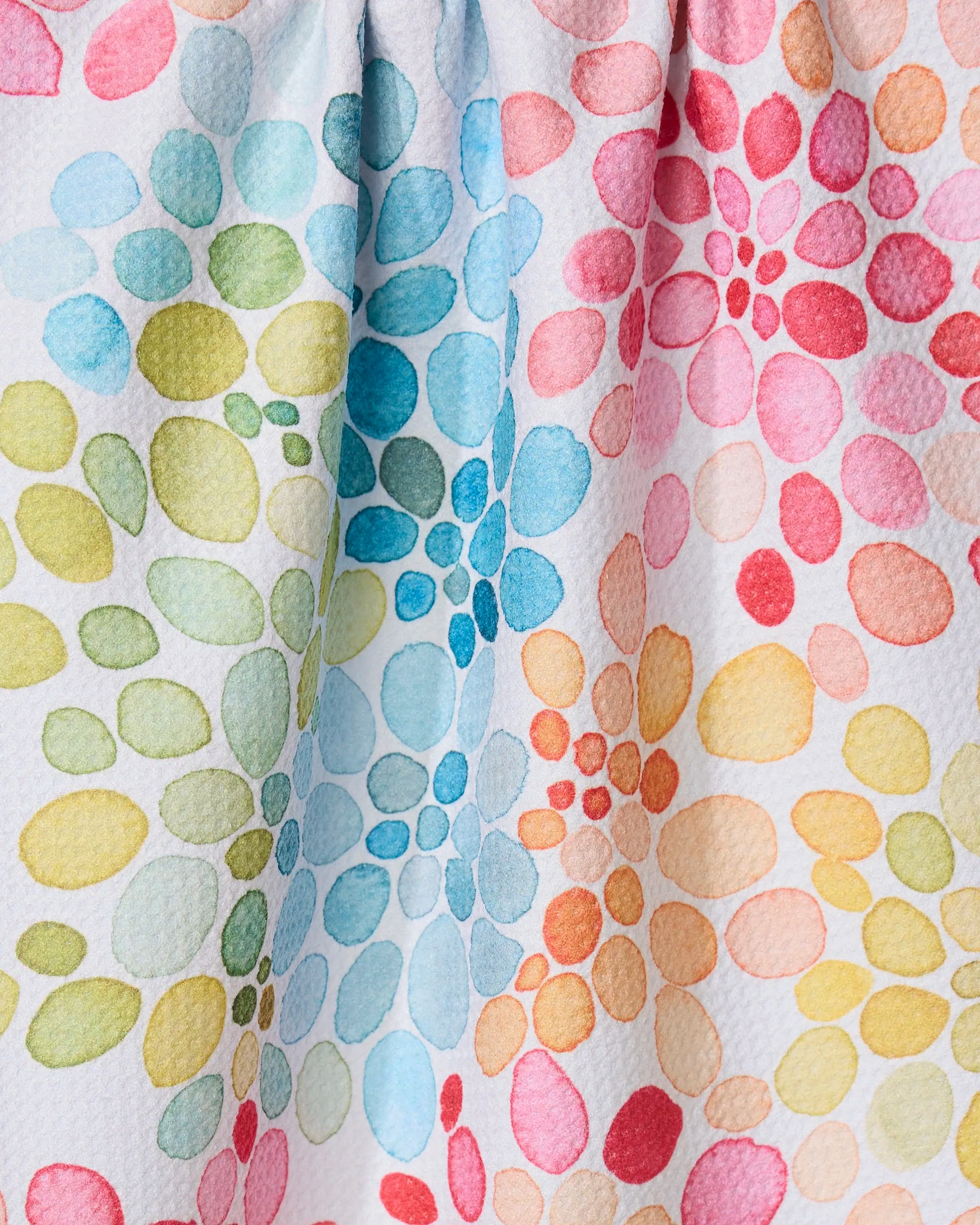The Bright Bouquet dish towel by GEOMETRY features vibrant watercolor floral patterns on textured white fabric. Ultra-absorbent with charming folds and shadows, it adds a lively touch to your kitchen essentials.